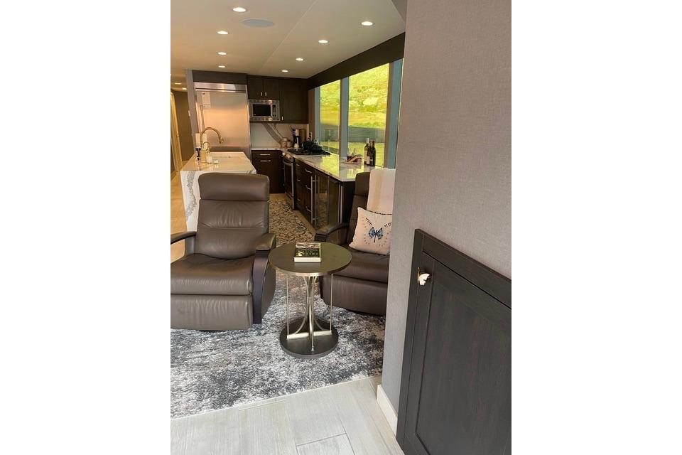 Luxurious interior of 2021 Adonia The Queen Elizabeth with modern kitchen and seating area.