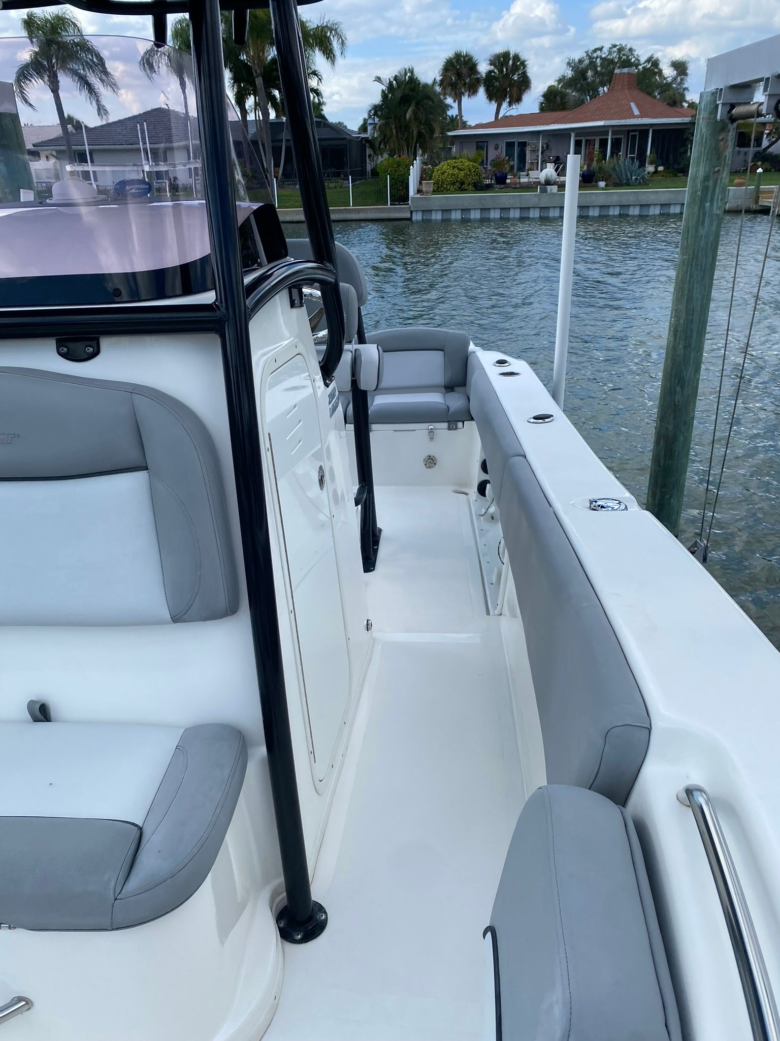 NauticStar Legacy 2021 boat docked with gray seating.