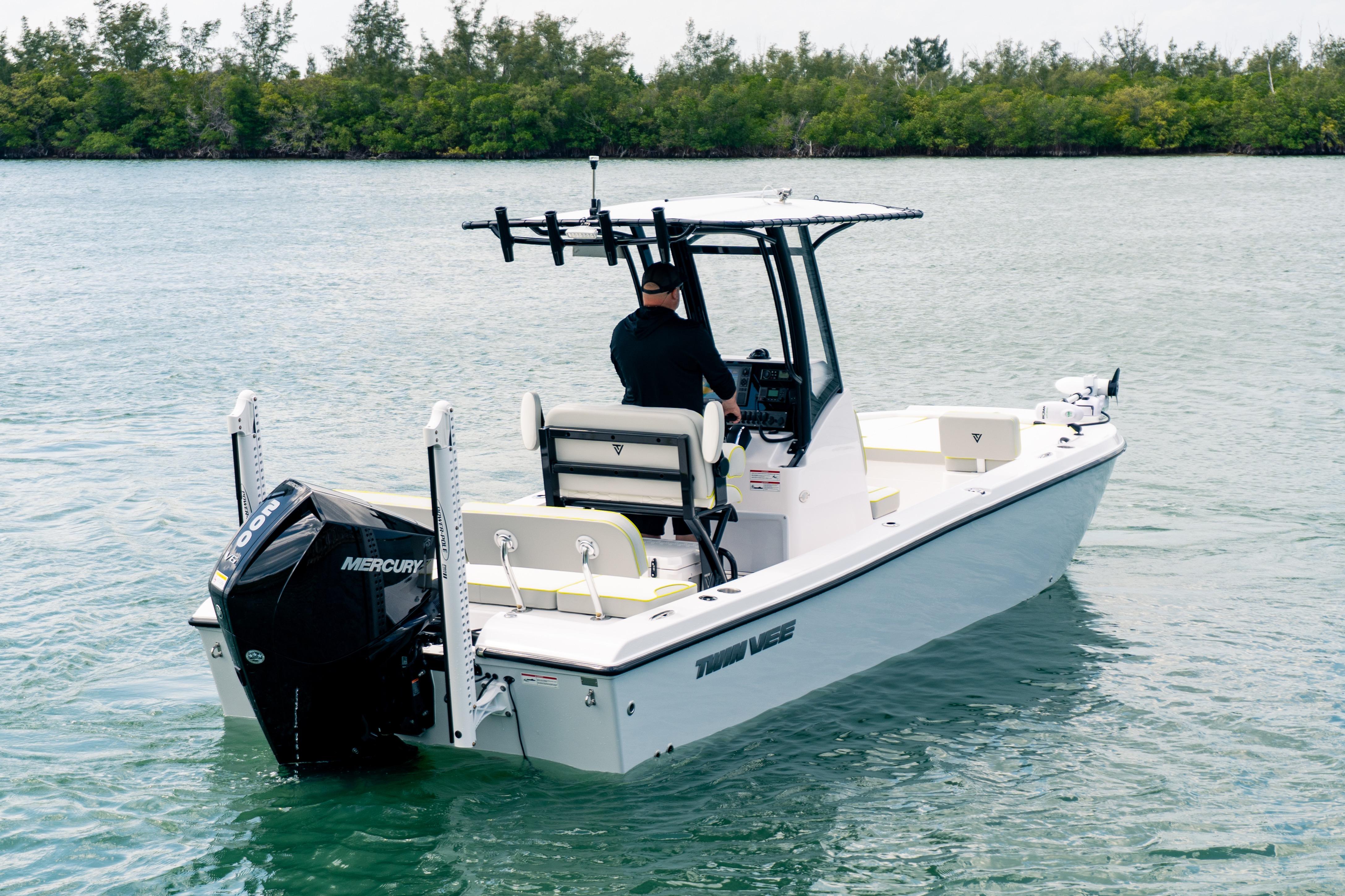 2026 Twin Vee 22 BayCat boat on water, featuring Mercury engine, with driver navigating.