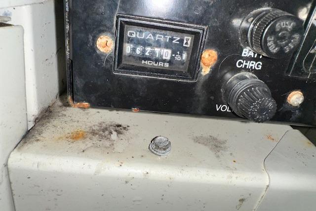 Control panel of a 2004 Carver 360 Mariner with hour meter and battery charge knob.