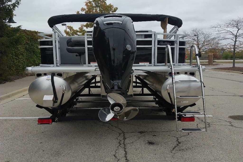 2026 Sun Tracker SportFish 20 DLX pontoon boat, rear view with motor and ladder.