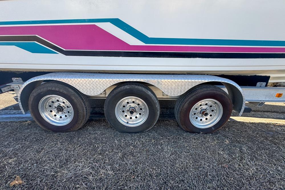 Triple-axle trailer with vibrant graphics on a 1989 Formula 292 SR-1 boat.
