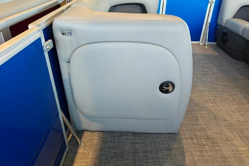 2026 Sun Tracker Party Barge 18 DLX interior seating with blue paneling and gray upholstery.