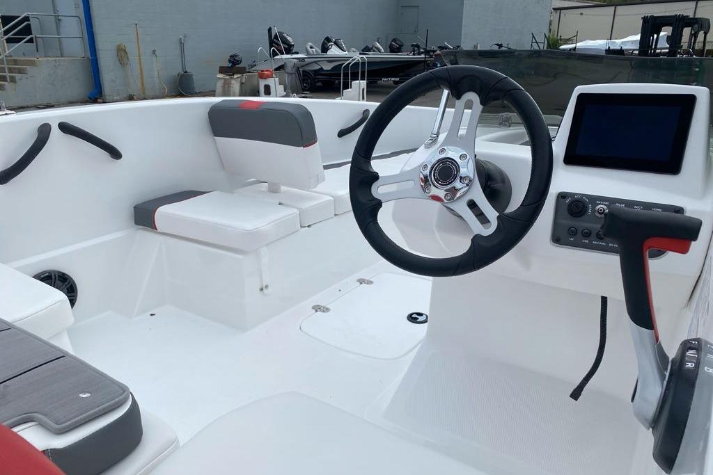 2026 Tahoe T16 boat interior with steering wheel, seating, and control panel.