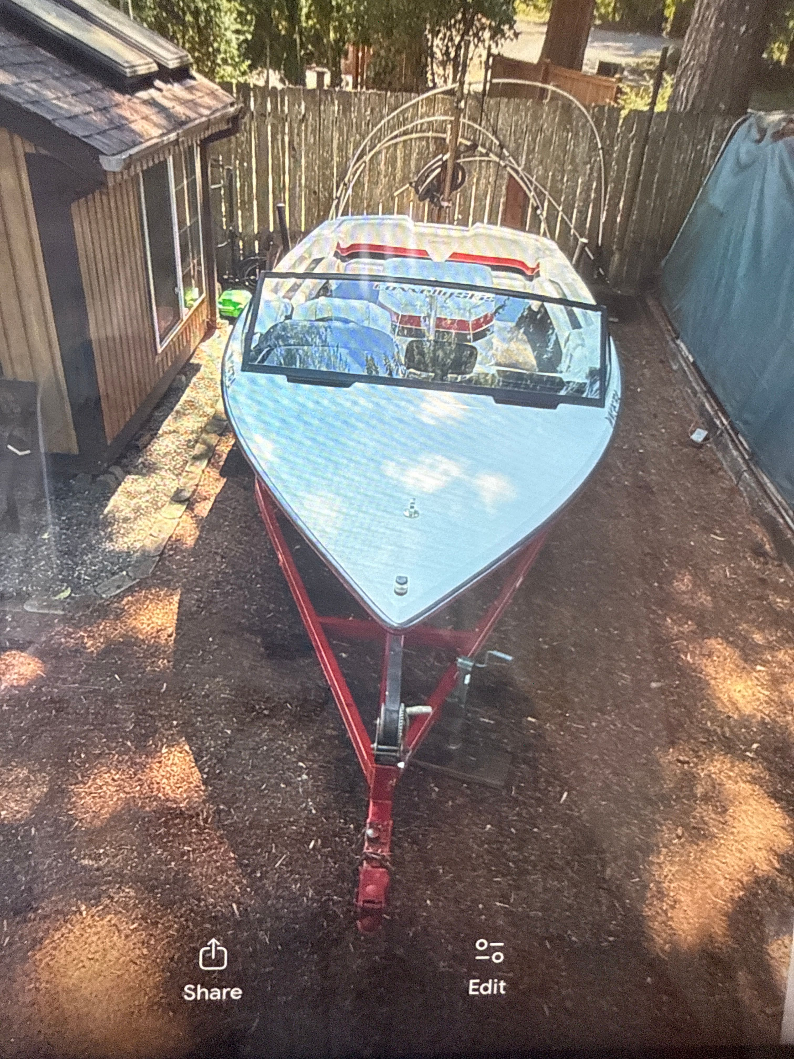 1990 Correct Craft Ski Nautique parked on trailer outdoors.