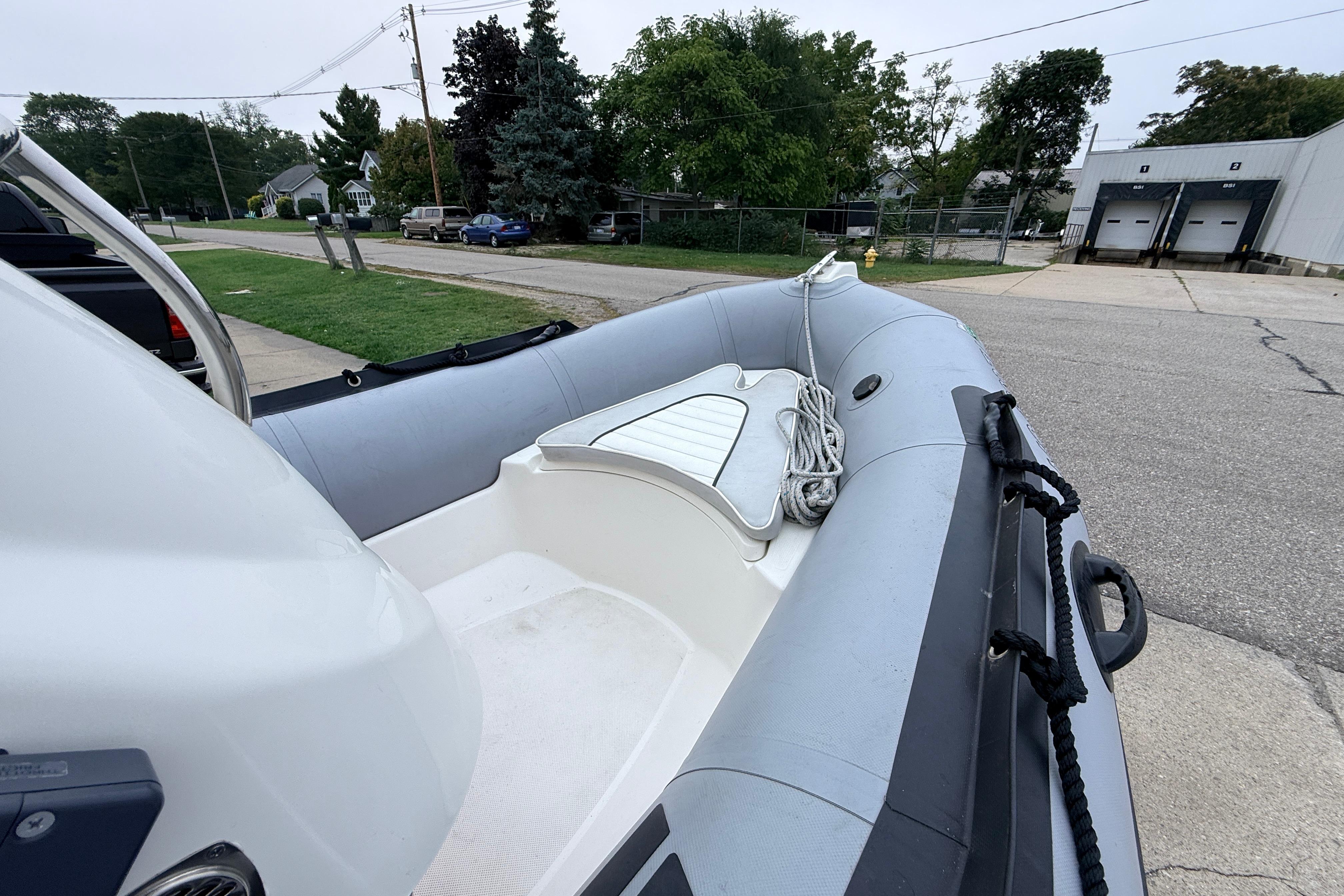 2014 Zodiac Pro Classic 420 inflatable boat parked on a street, featuring a clean interior.