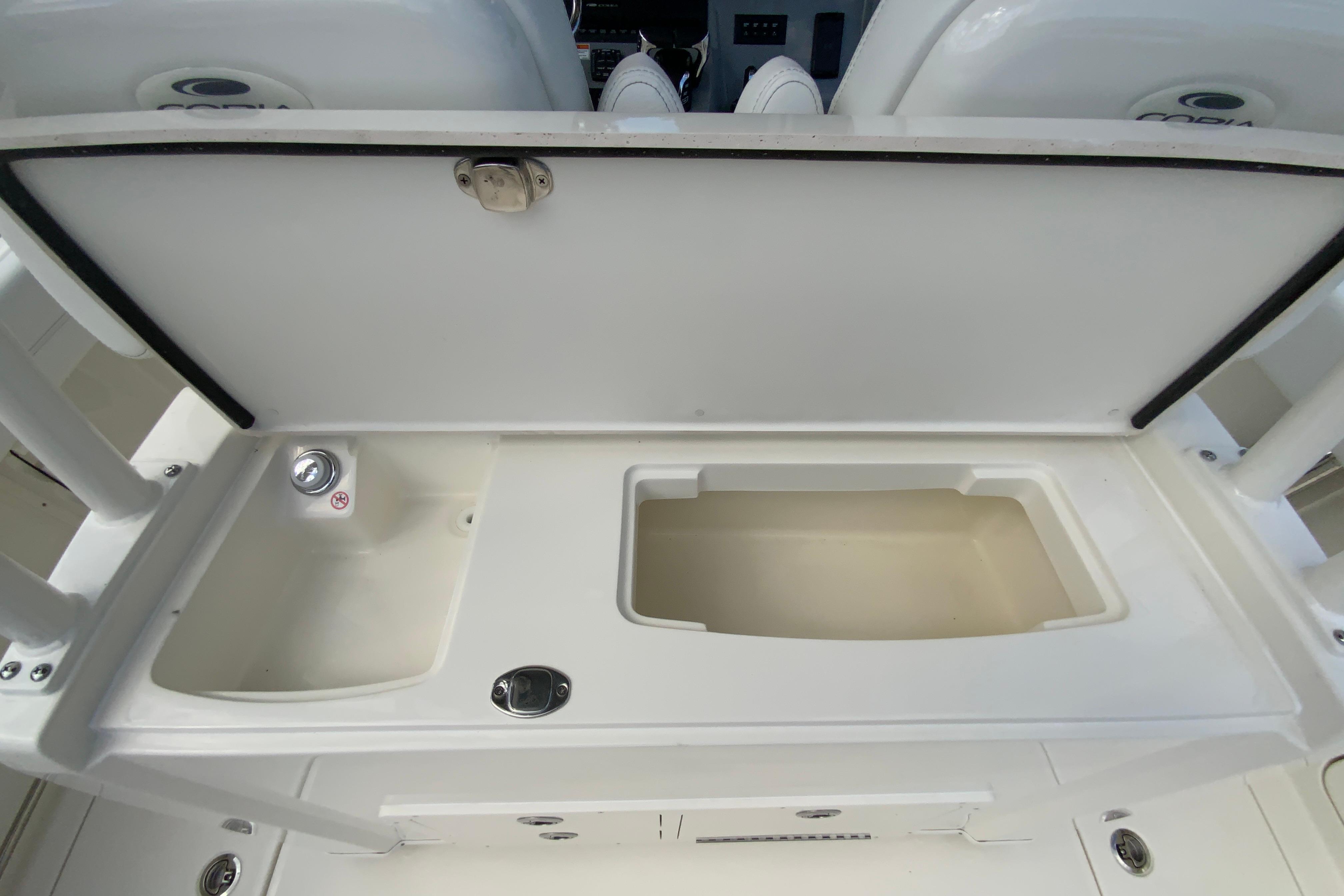 Open storage compartment on 2027 Cobia 320 Center Console boat.
