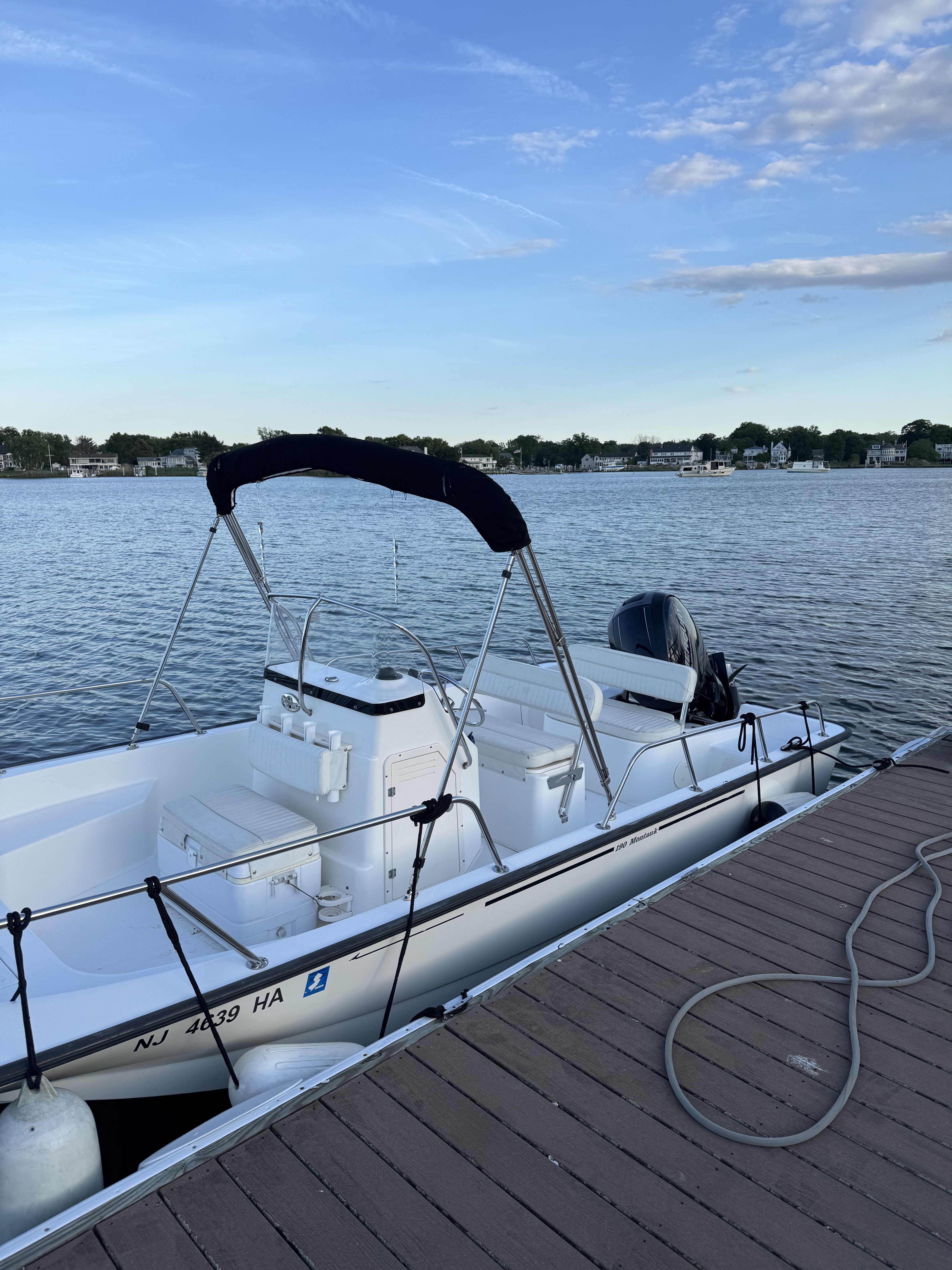 2007 Boston Whaler 190 Montauk boat docked by calm waters.