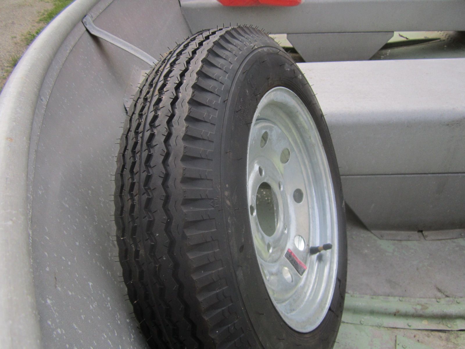 A spare tire is placed inside a boat.
