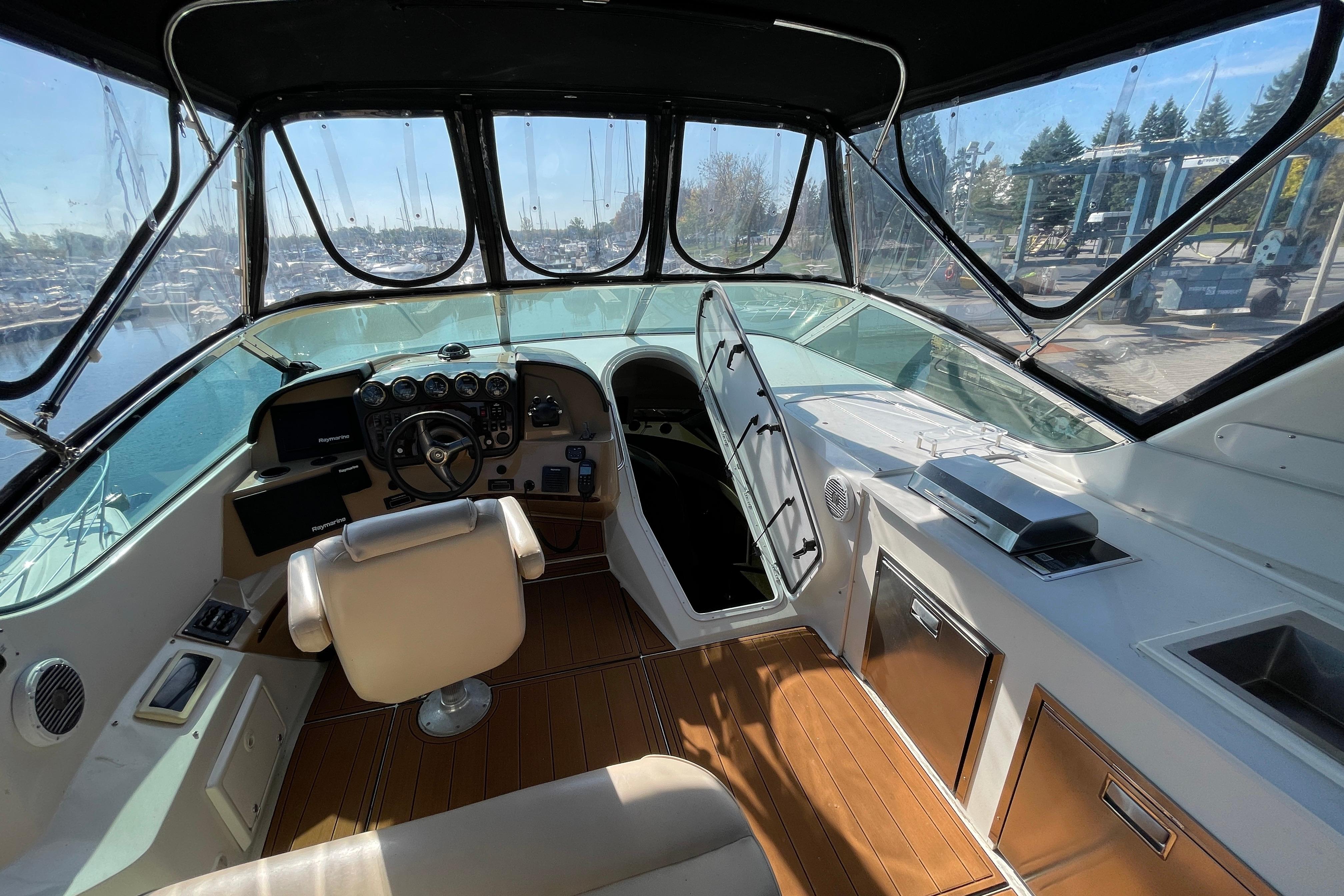 Interior of 2002 Carver 570 Voyager Pilothouse with helm and seating area.