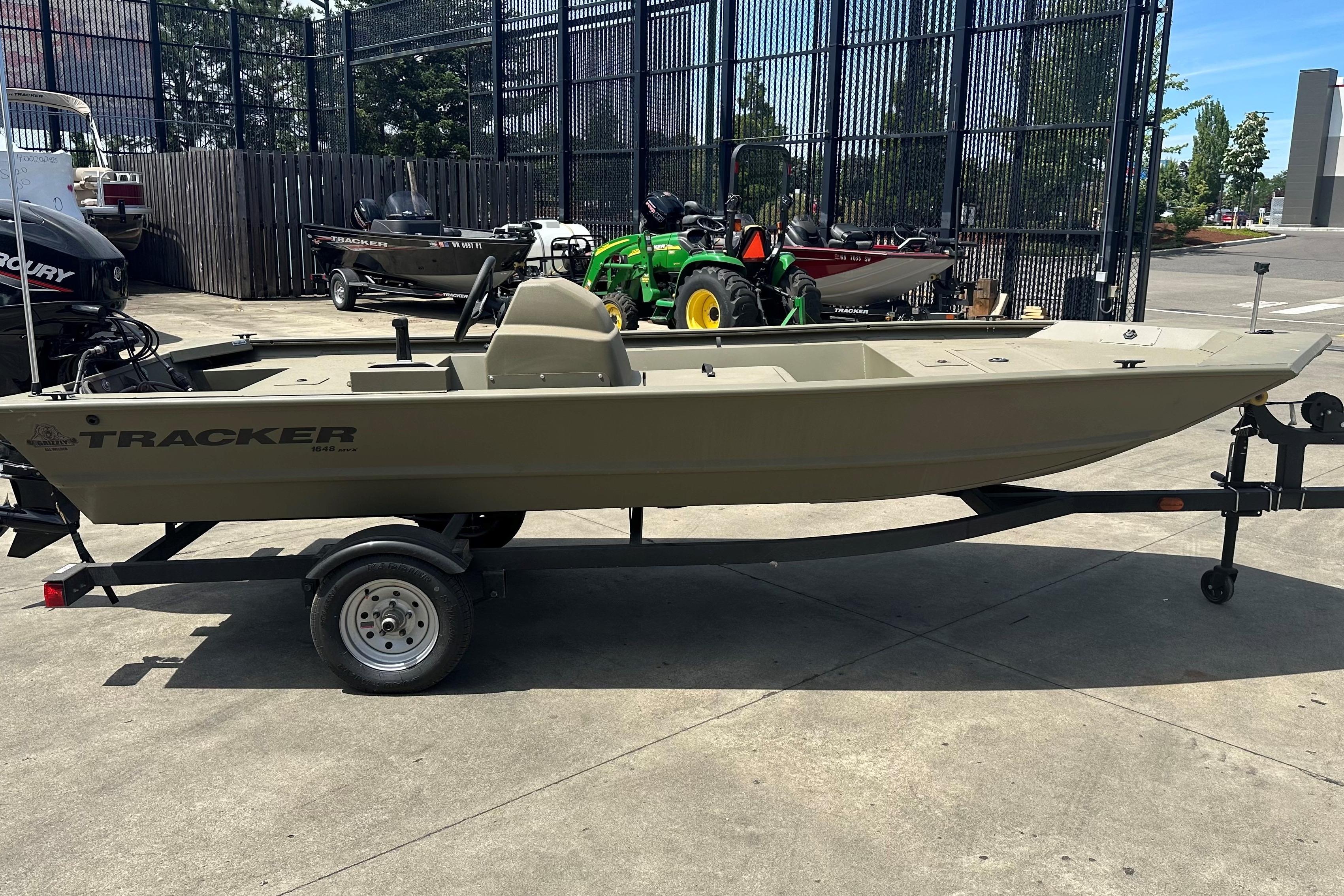 2026 Tracker Grizzly 1648 SC boat on trailer in outdoor setting.