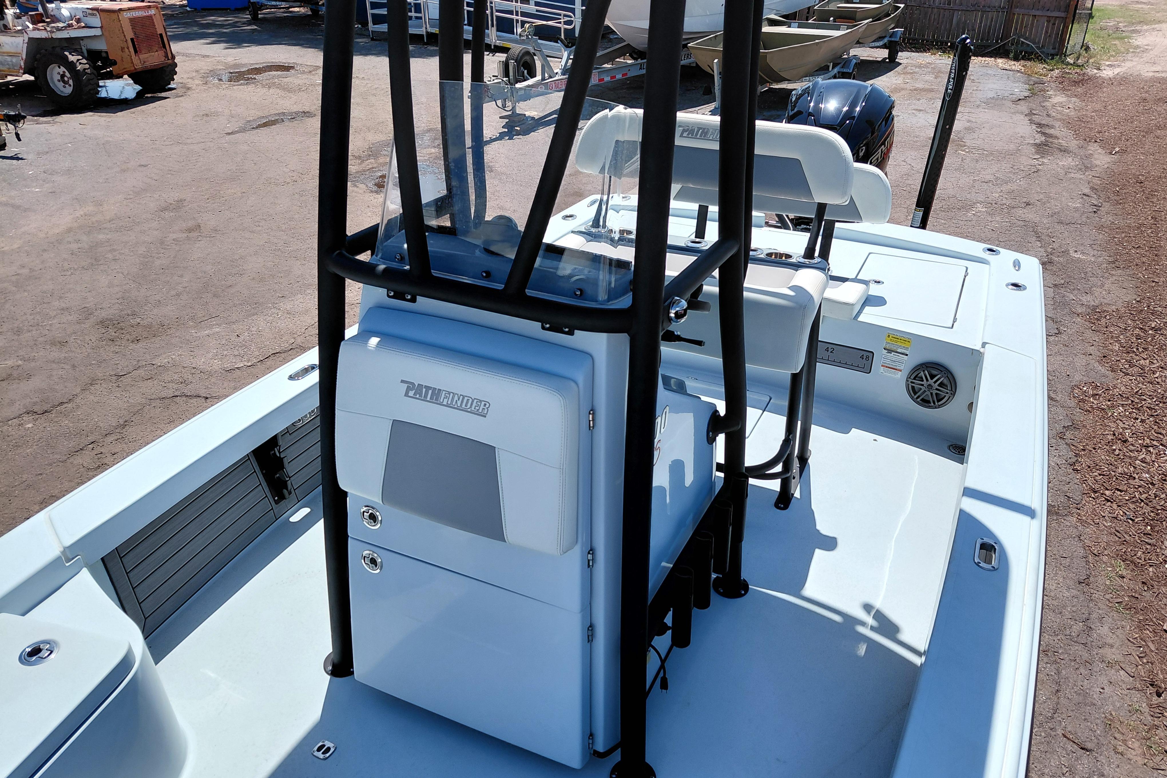 2022 Pathfinder 2300 HPS boat interior with seating and console, parked outdoors.