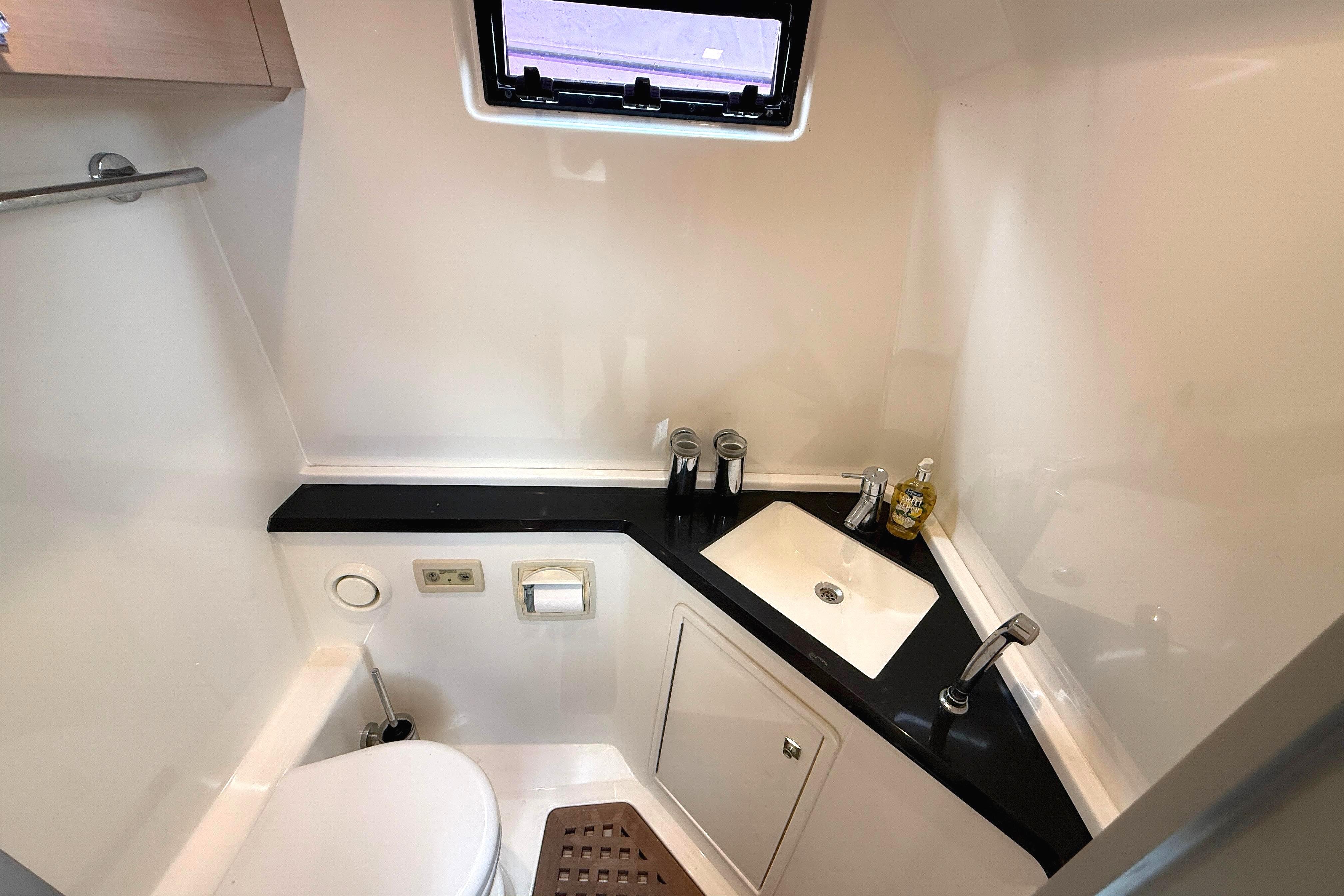 Compact bathroom in 2013 Windy SR52 yacht with sink, toilet, and window.