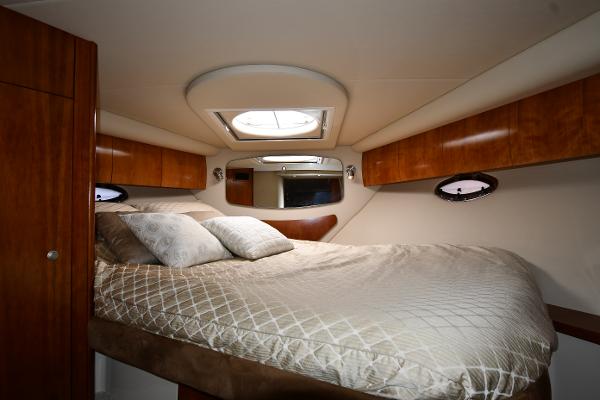 Luxurious cabin interior of 2010 Cruisers Yachts 390 Sports Coupe with cozy bedding.