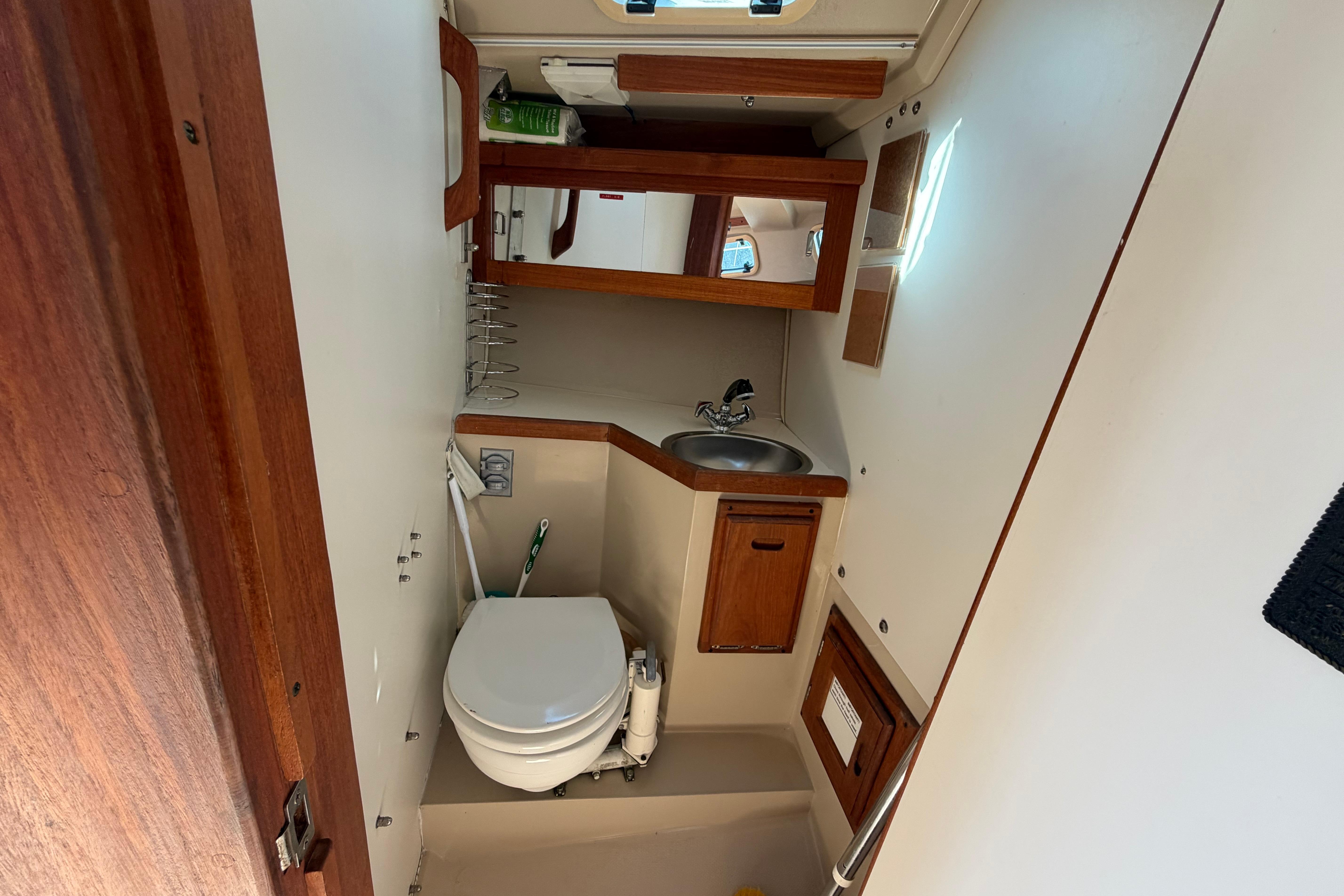Interior of 1988 Catalina 30 MkII sailboat bathroom with sink and toilet.