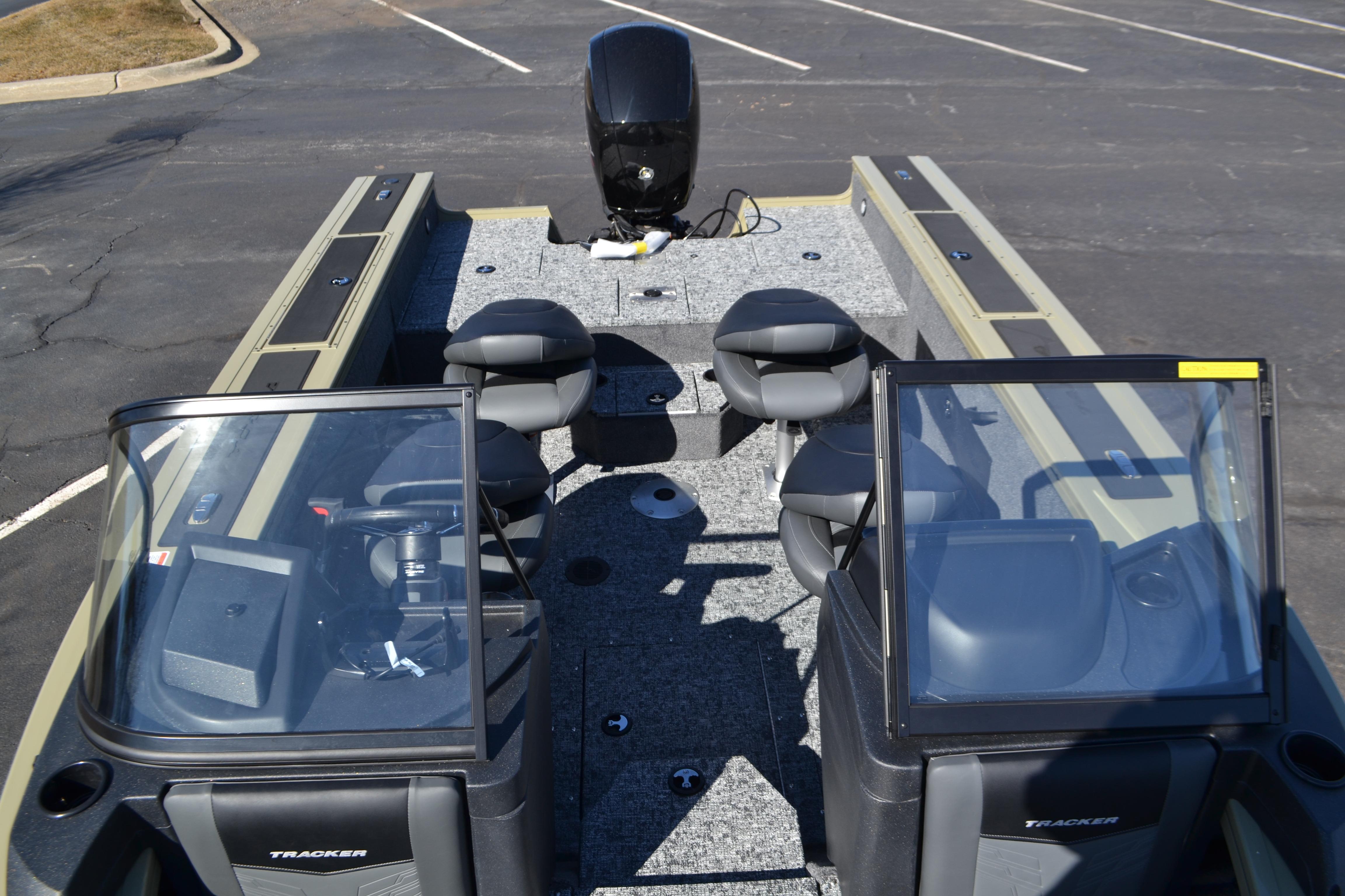 2026 Tracker Targa V-18 WT boat interior with seating and console, parked on asphalt.