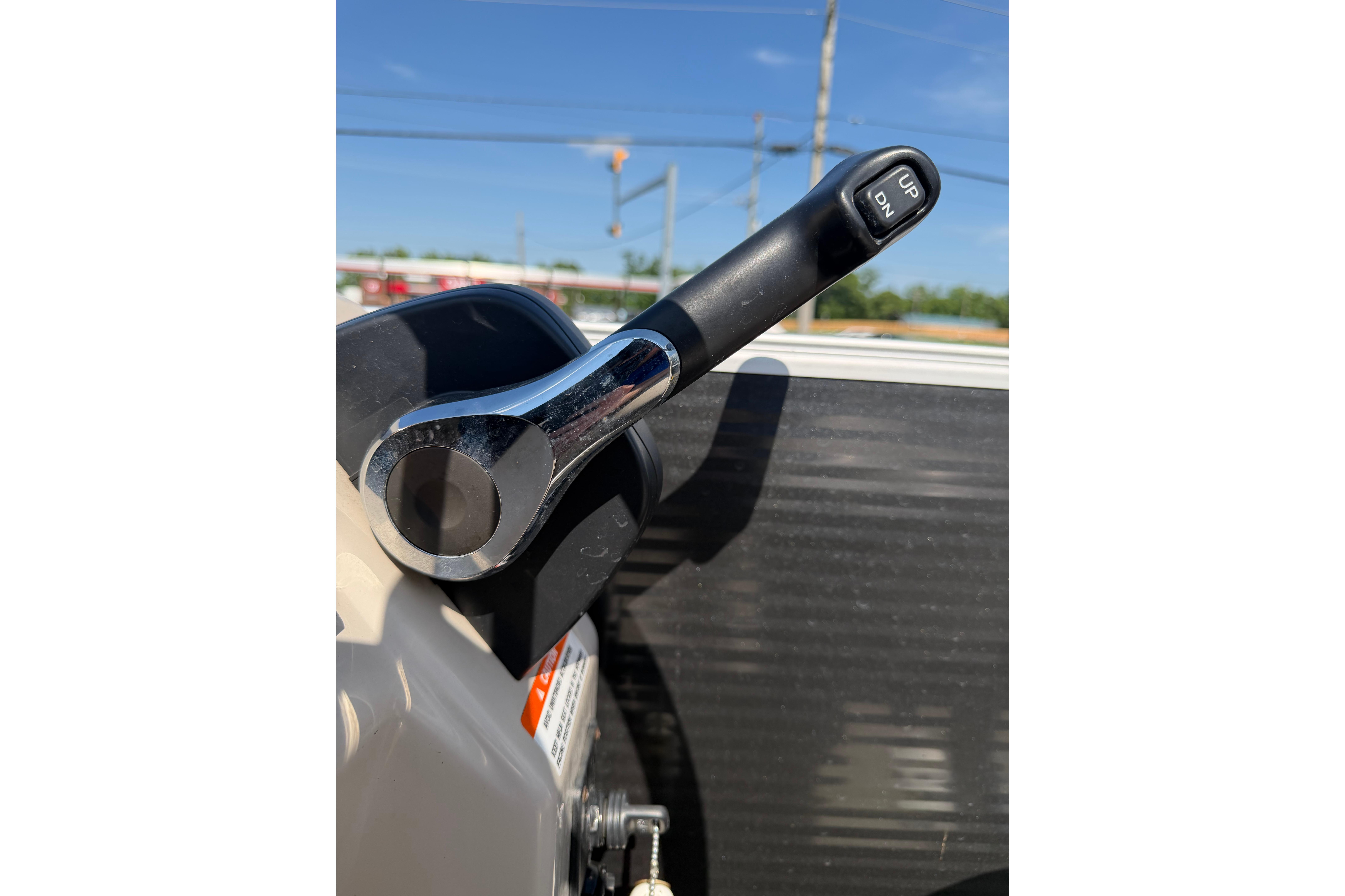 Close-up of a 2018 Bennington 21 SF boat throttle lever under clear blue sky.