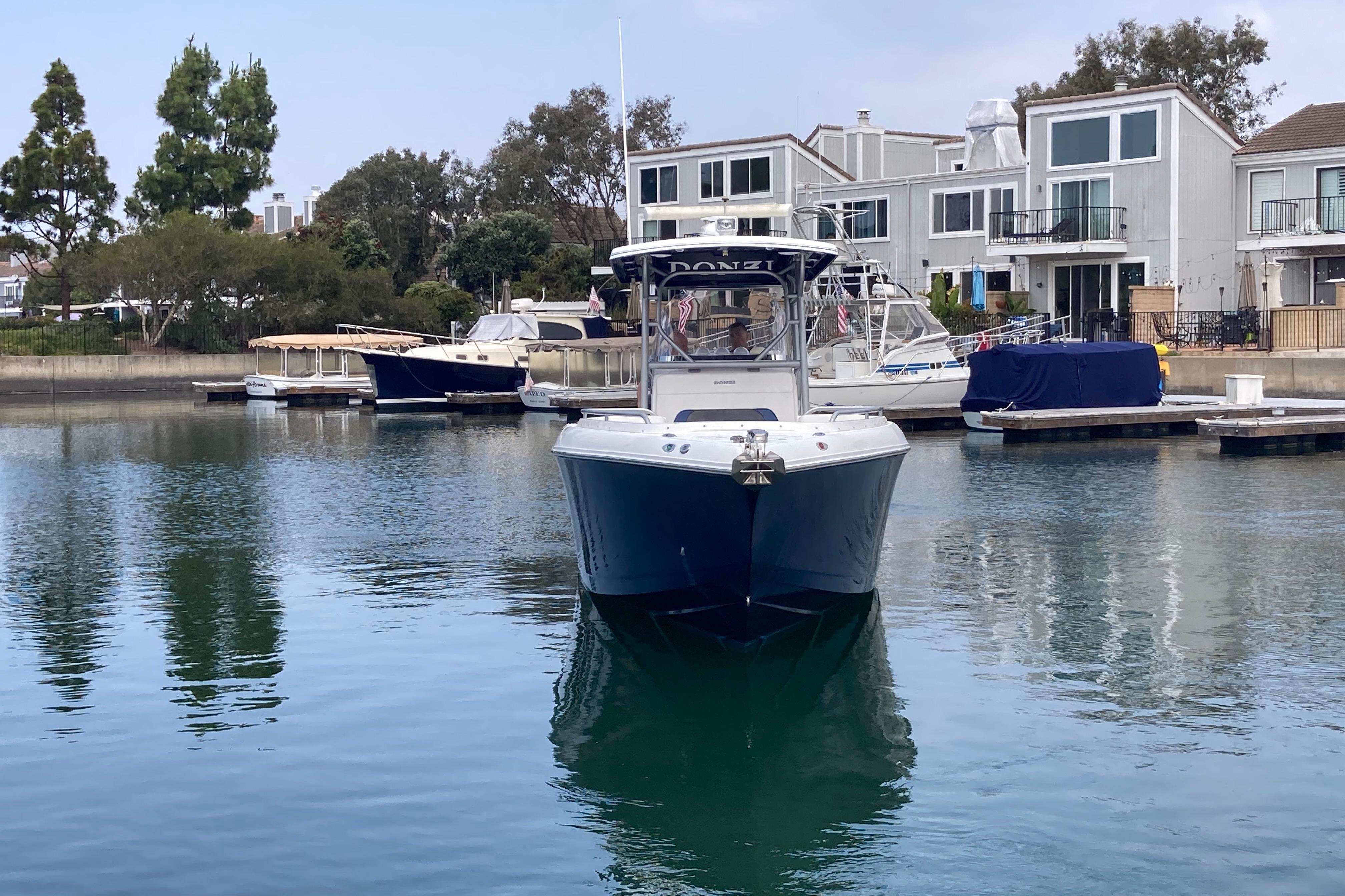 2011 Donzi 38 ZFX Open boat docked in a serene marina setting.