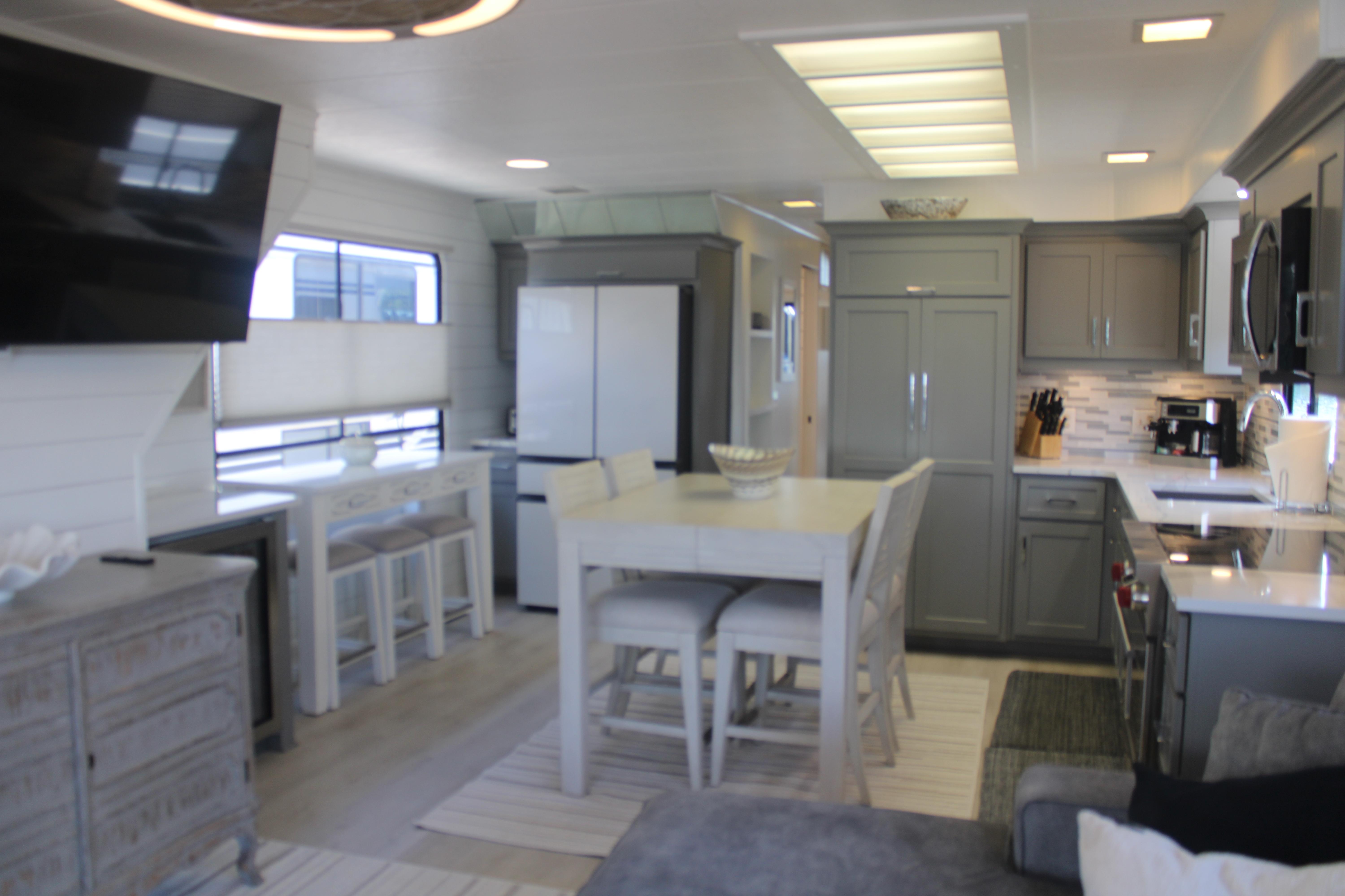 Modern kitchen interior in a 1992 Sumerset 66 houseboat, featuring sleek cabinetry and dining area.