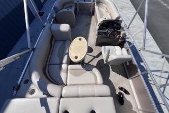 2012 Avalon Tahoe boat interior with beige seating and steering console.