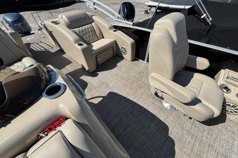 Luxurious seating on a 2014 Bennington 2575 RCW pontoon boat with beige upholstery.