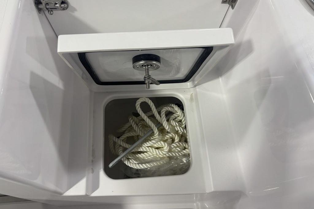 Storage compartment with rope in a 2026 Sportsman Open 252 Center Console boat.