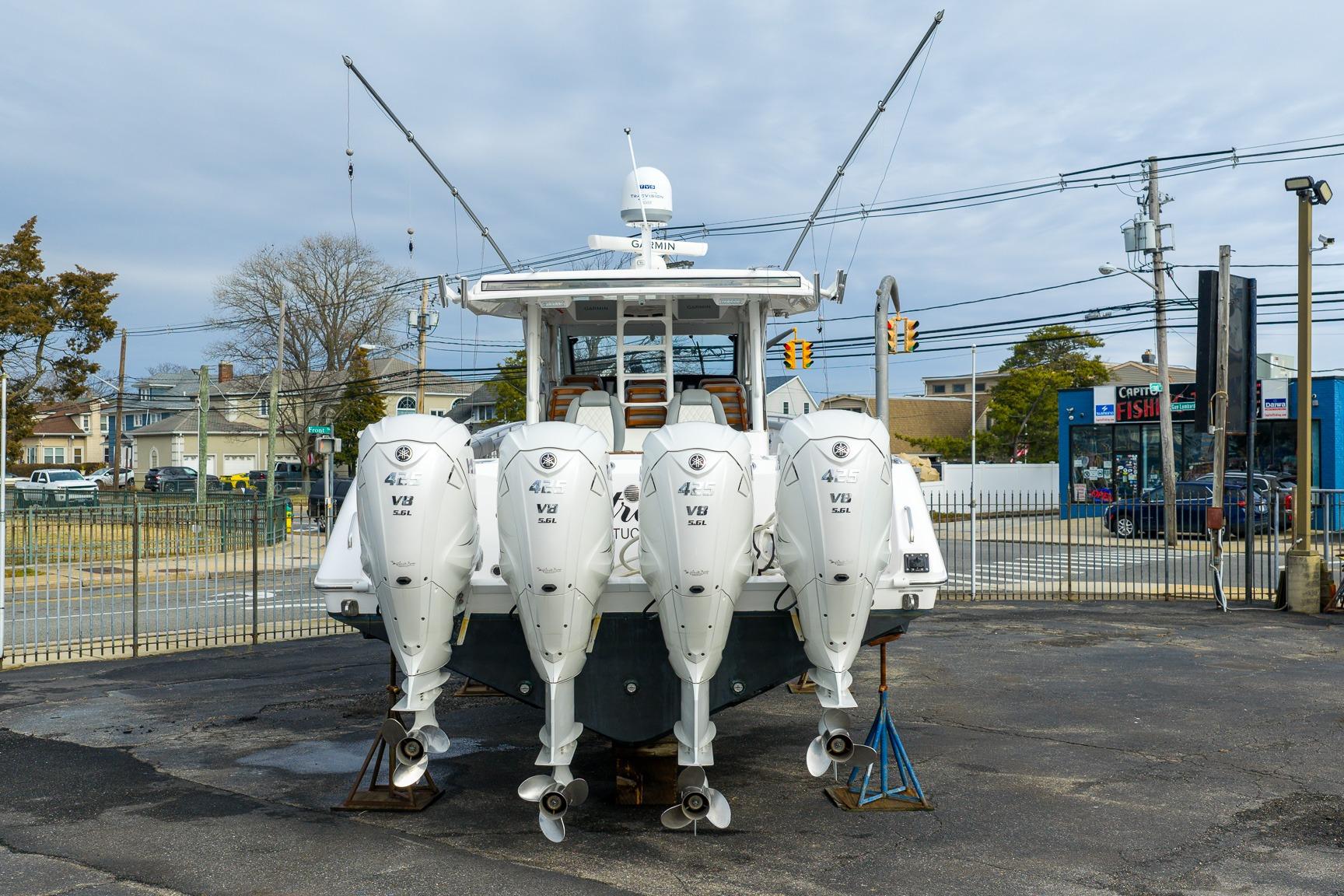 2023 Everglades 455 Center Console boat with four powerful outboard engines.