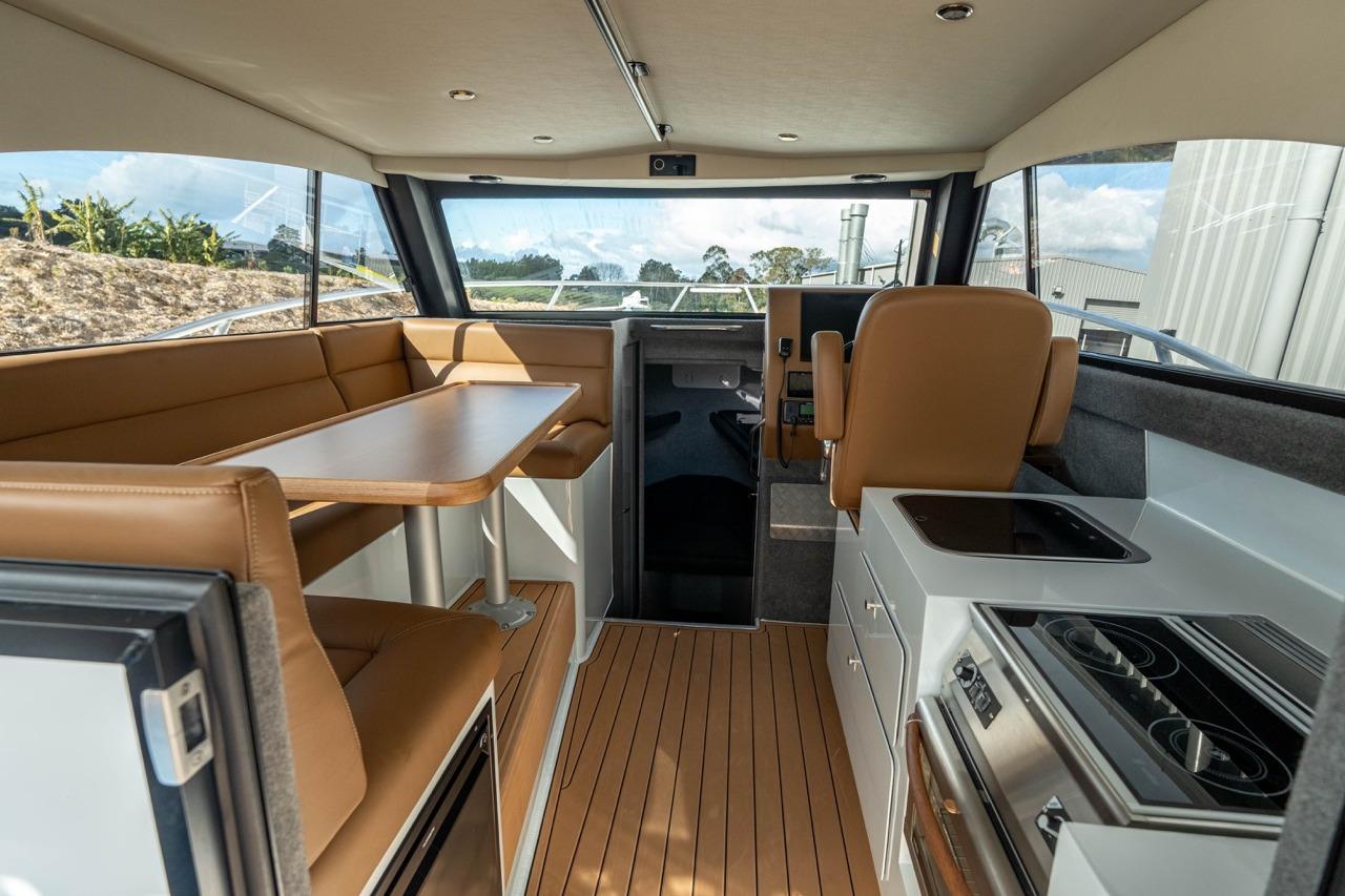 Interior of 2025 Makaira Gen 3 36 boat with modern seating and kitchen area.
