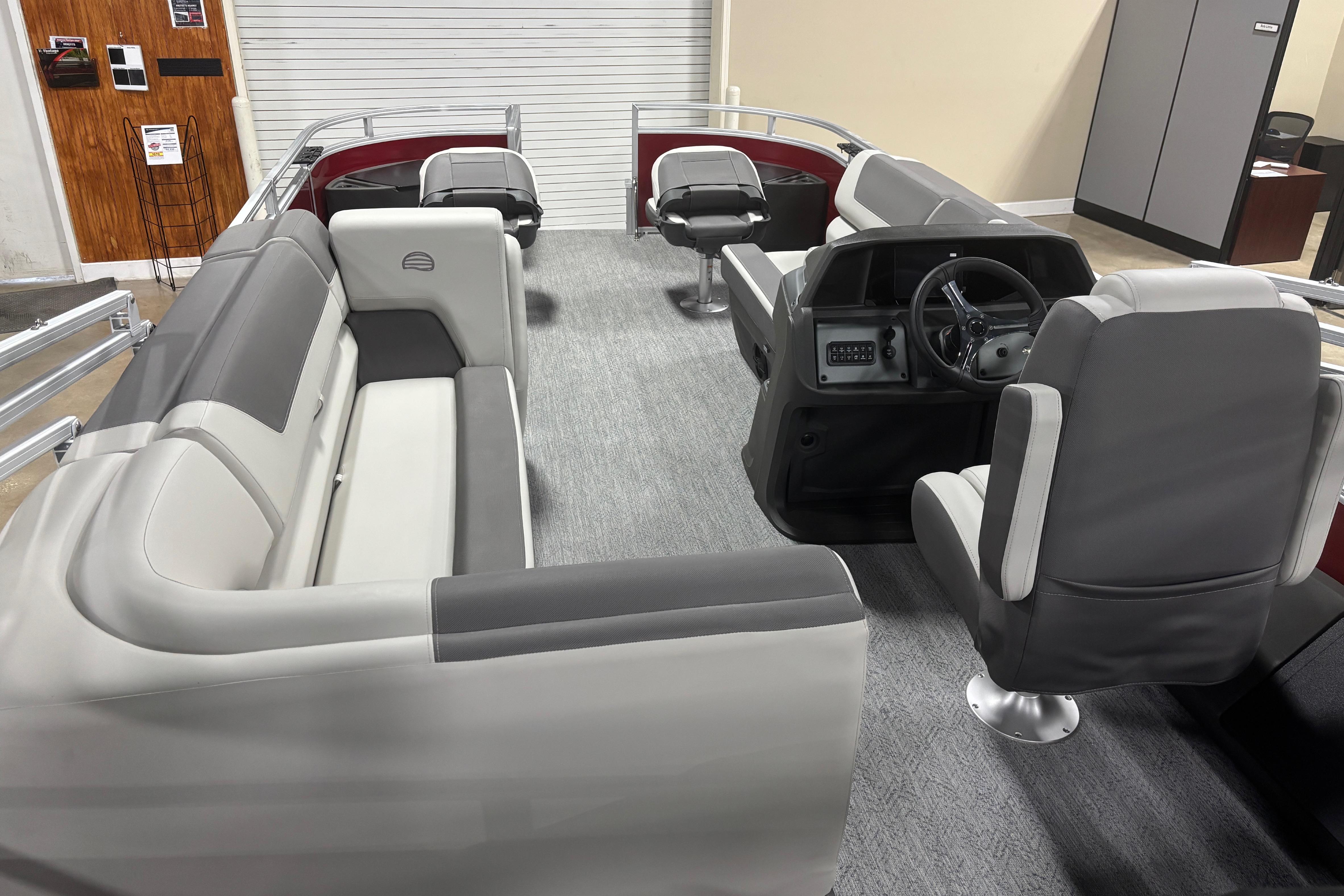 2026 Sun Tracker Fishin' Barge 22 DLX interior with spacious seating and modern helm.