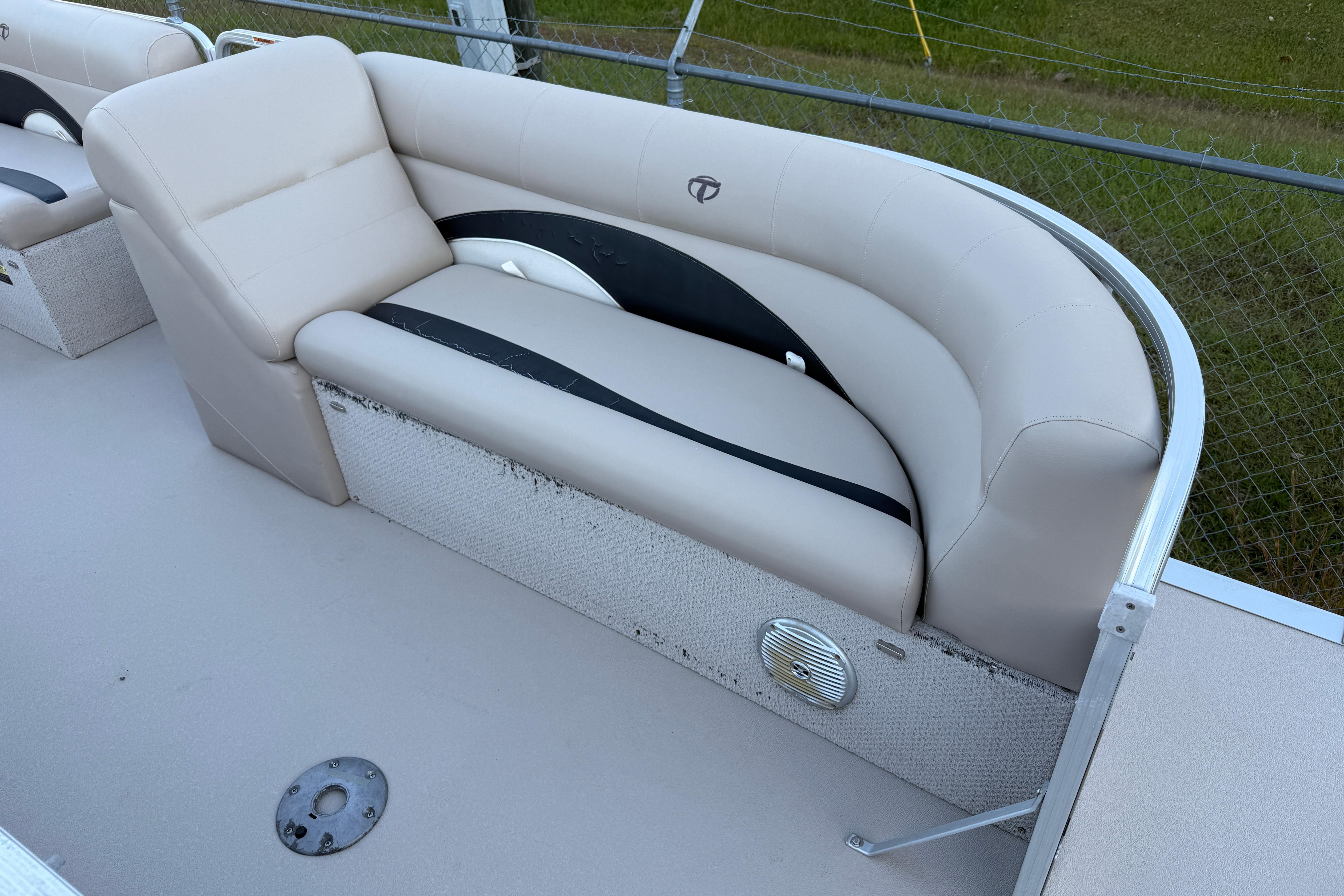 2011 Tahoe Pontoon 2485 DRL boat seating with beige upholstery and speaker detail.
