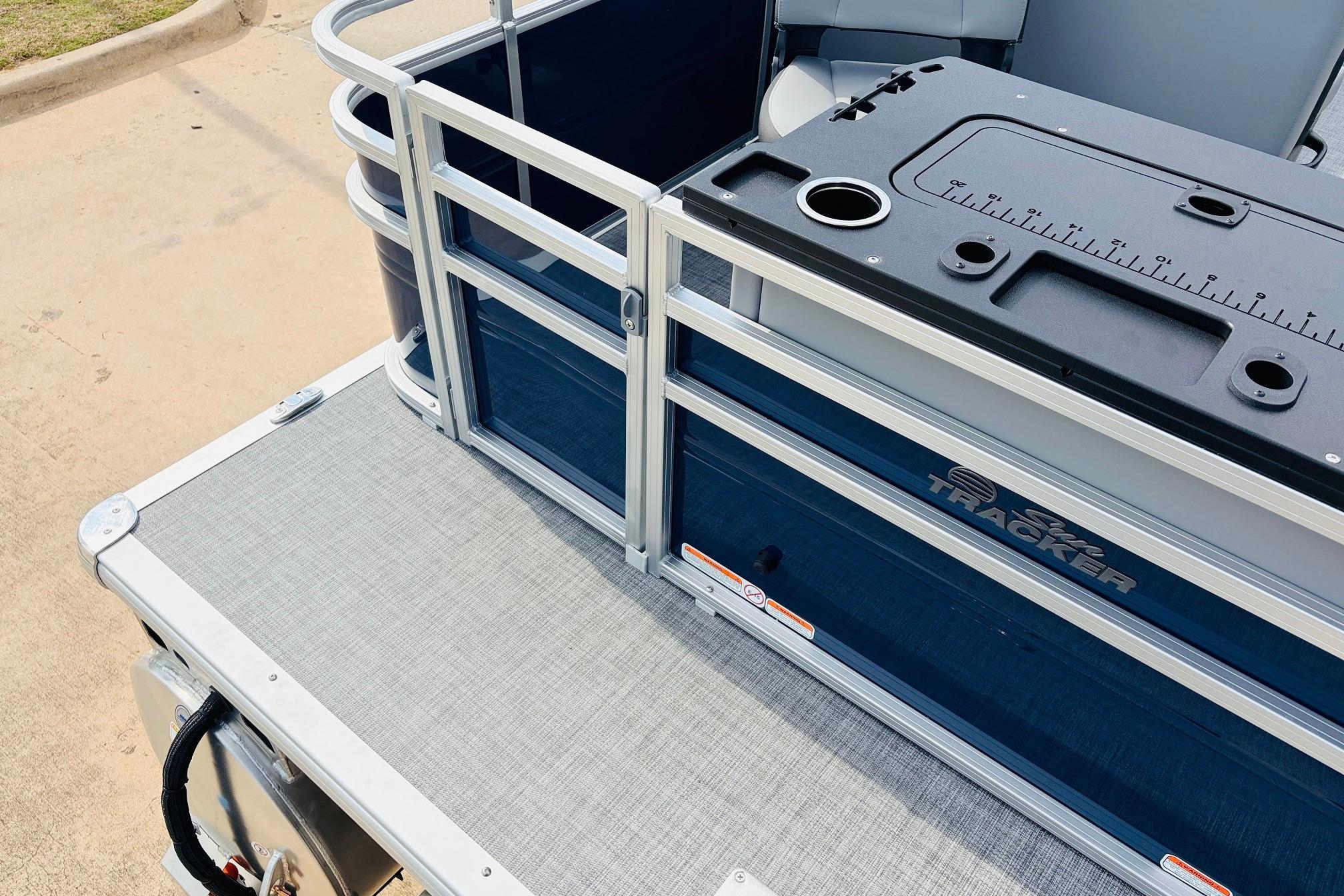 2026 Sun Tracker SportFish 22 DLX pontoon boat with fishing station and seating area.