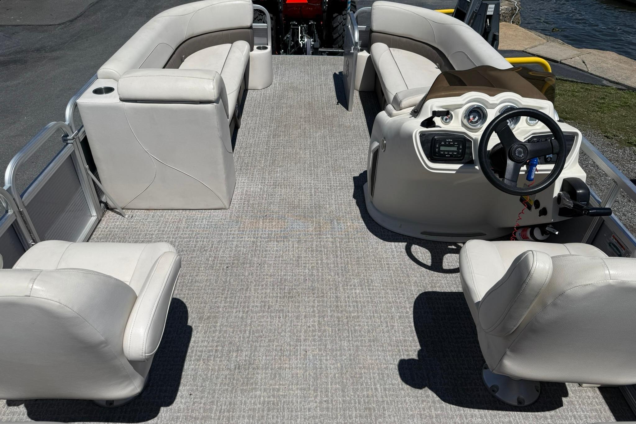 2019 Avalon GS Quad Lounge 25' pontoon boat interior with plush seating and steering console.