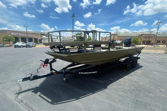 2026 Tracker Grizzly 2072 CC Sportsman boat on trailer, parked outdoors under blue sky.
