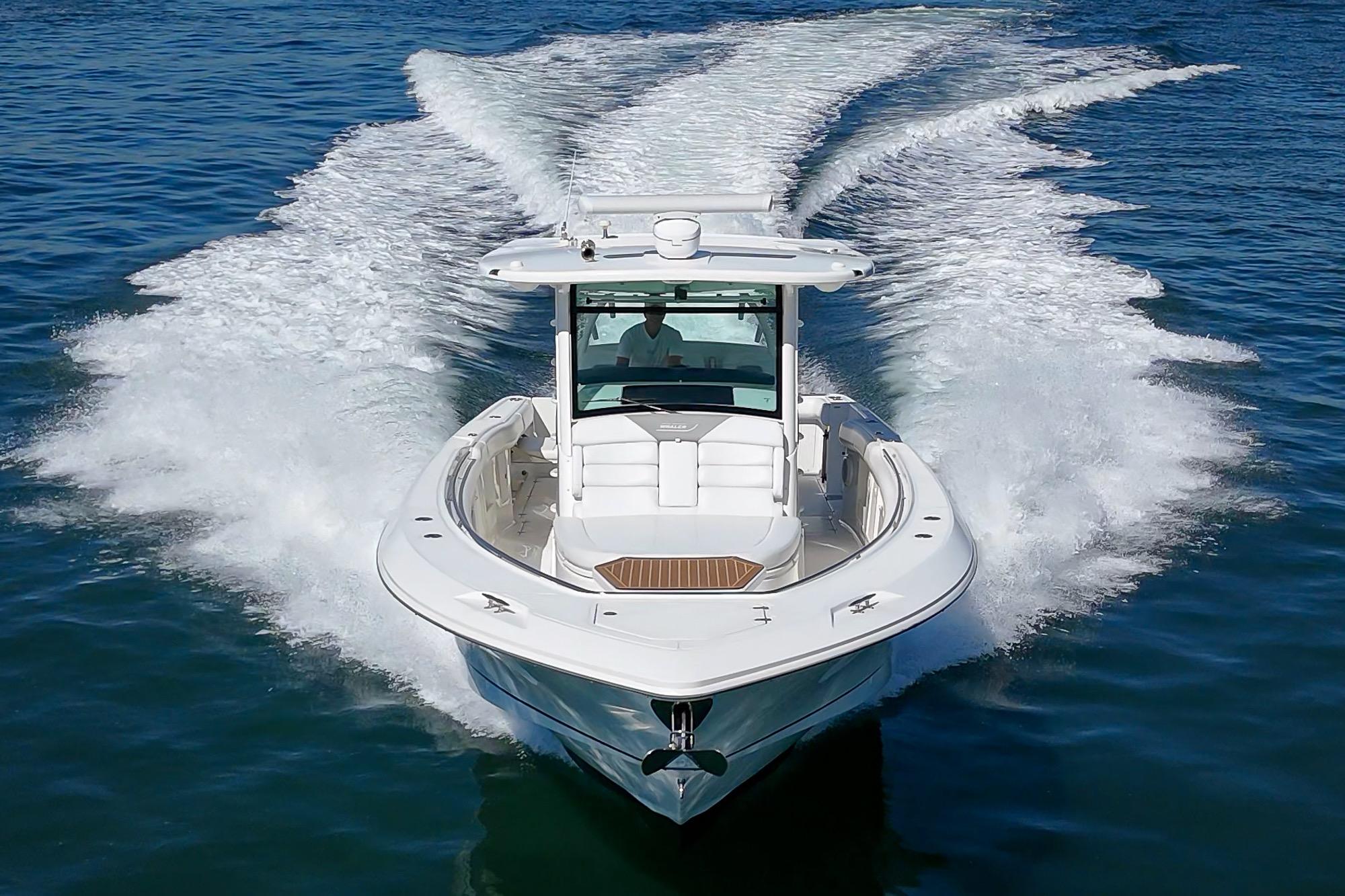 2015 Boston Whaler 370 Outrage cruising on open water, creating a dynamic wake.