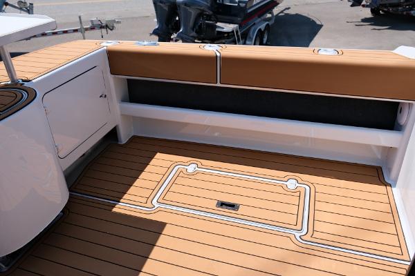 Makaira Gen3 800 boat deck, 2023 model, featuring teak flooring and cushioned seating.
