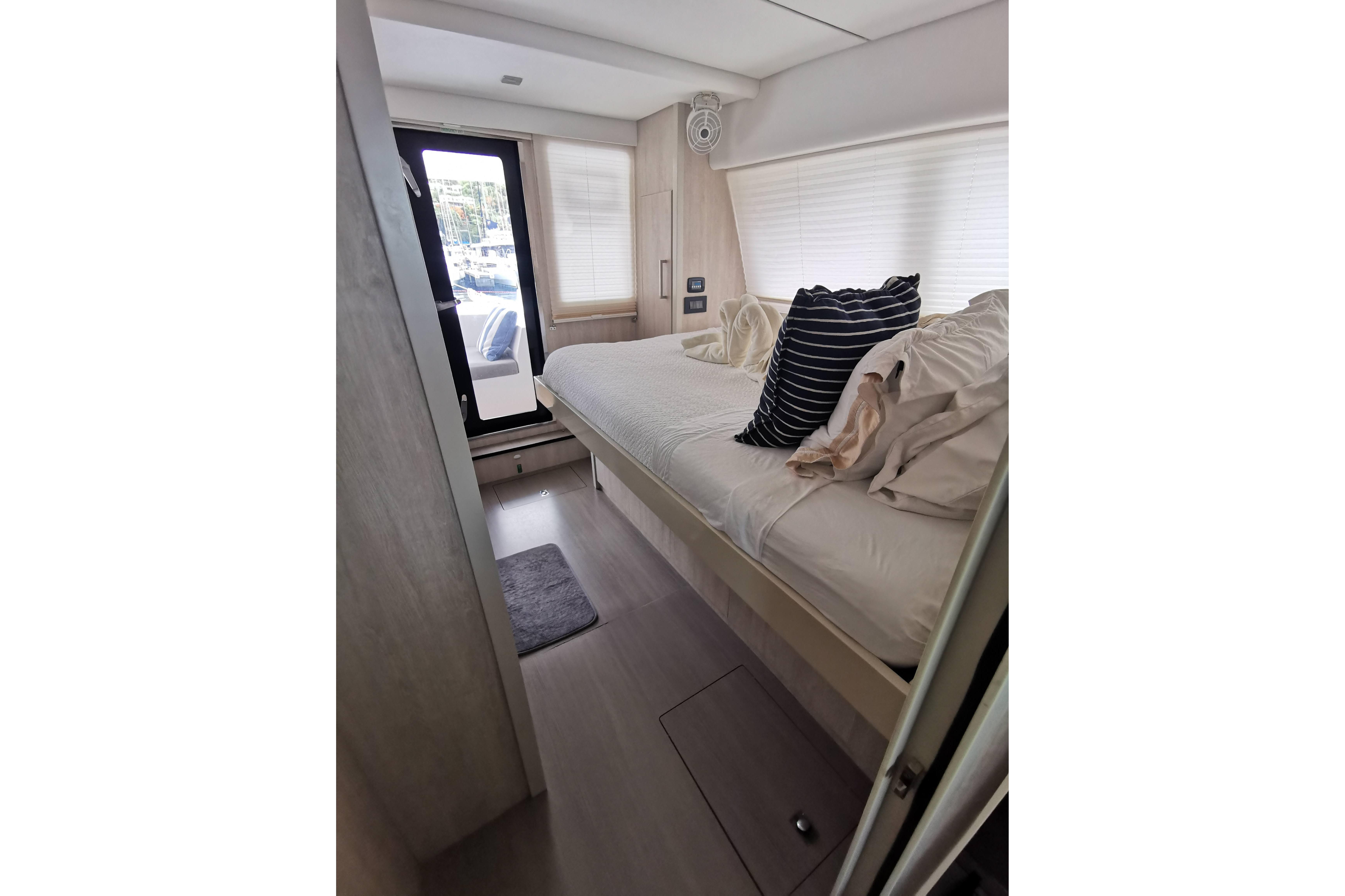 Luxurious bedroom interior of 2020 Leopard 58 yacht with modern decor and natural light.