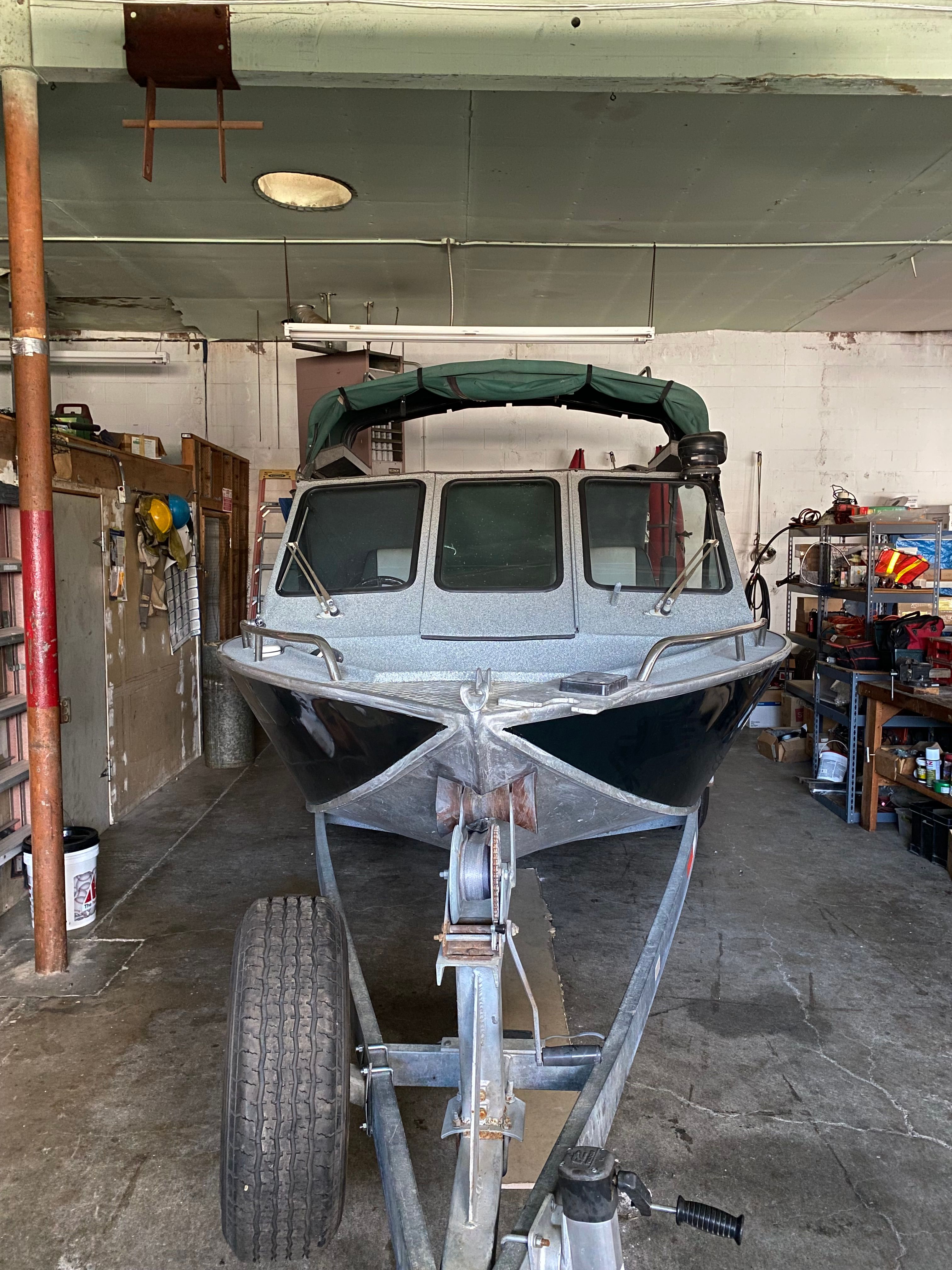 1993 Jetcraft Fastwater boat in a garage on a trailer.