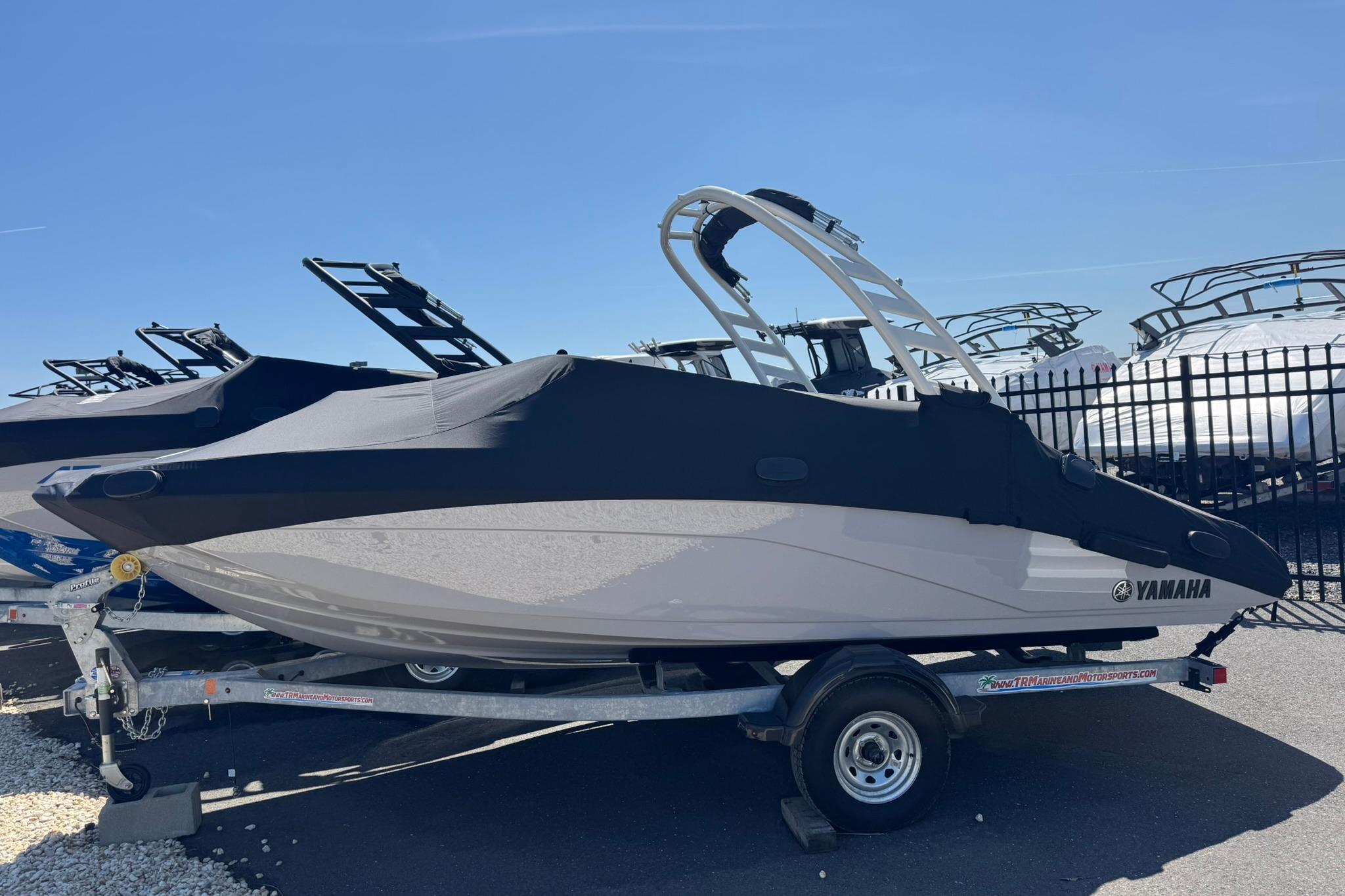 2026 Yamaha Boats 195S covered on trailer, parked outdoors under clear sky.