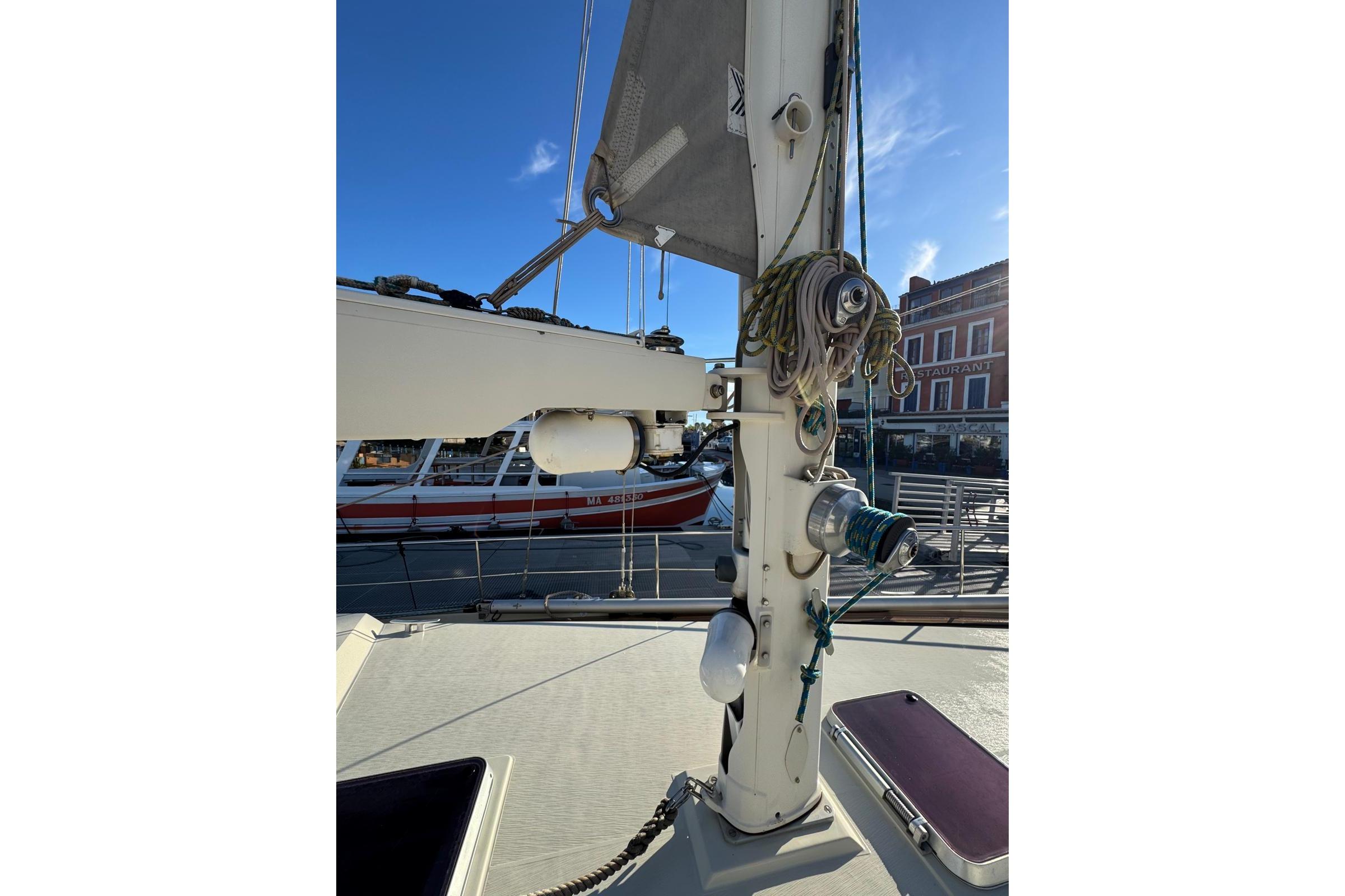 Sailboat mast and rigging on a 2002 Amel Super Maramu 2000 in a marina.