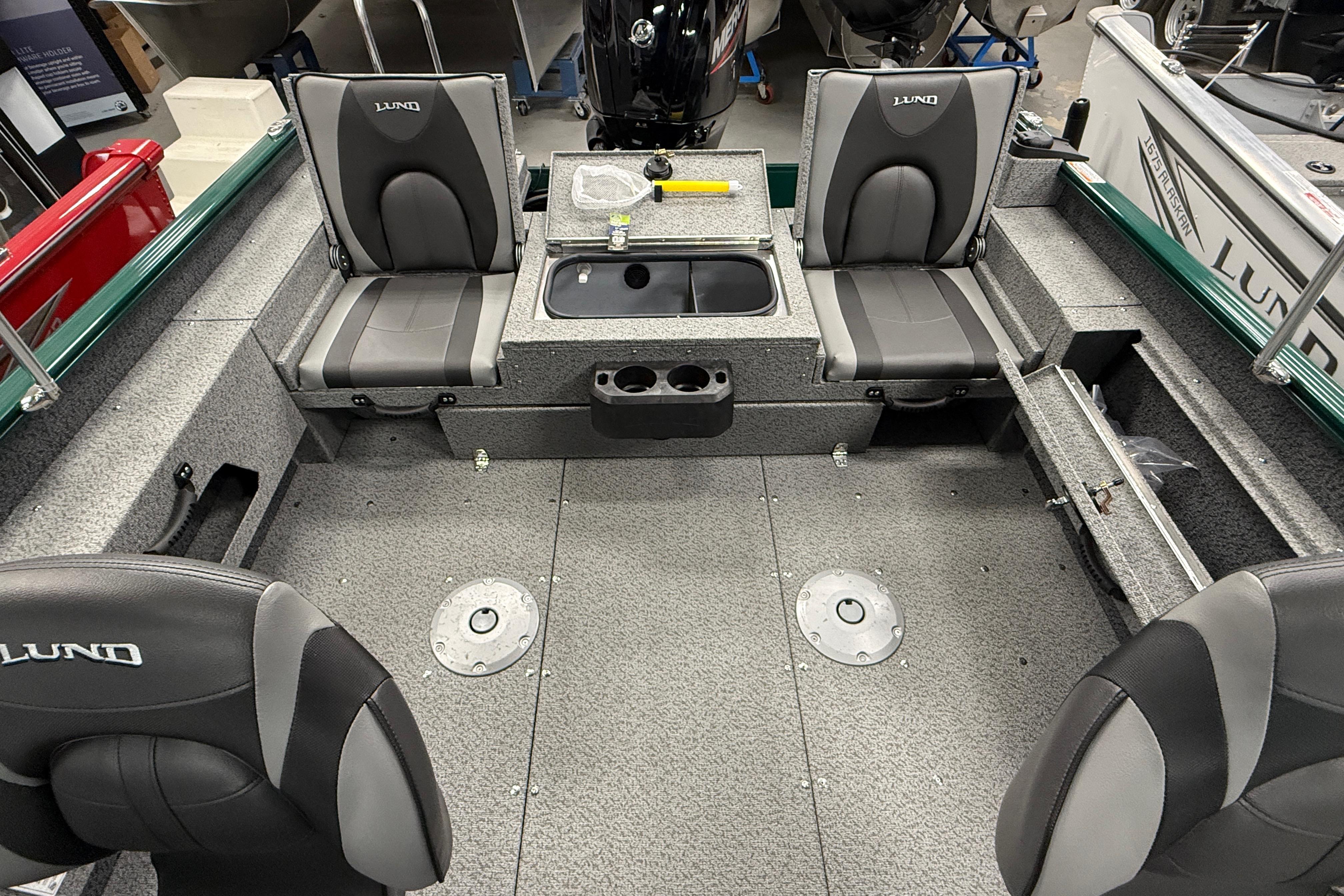 2026 Lund 1775 Adventure Sport boat interior with seating and storage compartments.