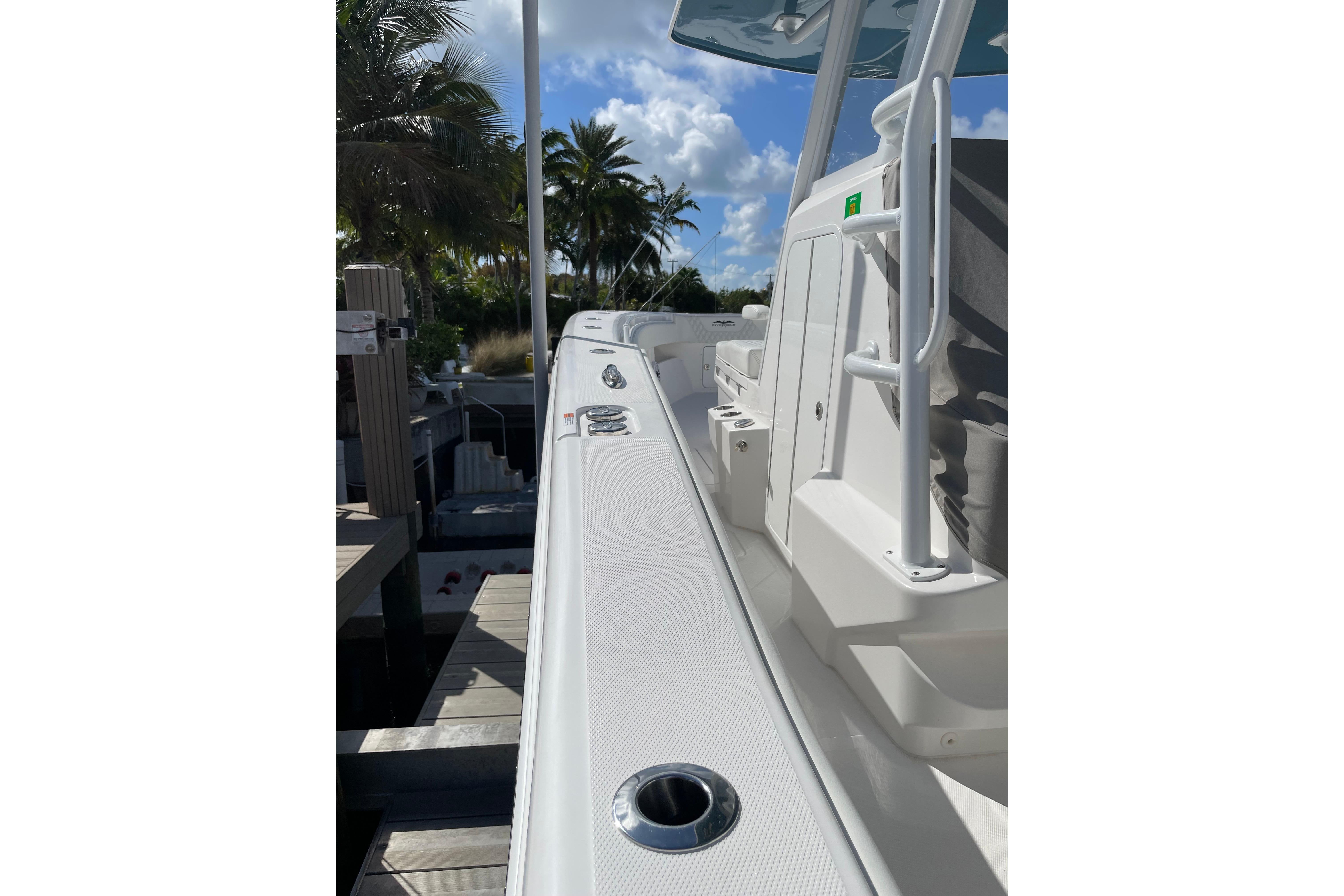 2024 Invincible 36 Open Fisherman boat docked, showcasing sleek design and spacious deck.