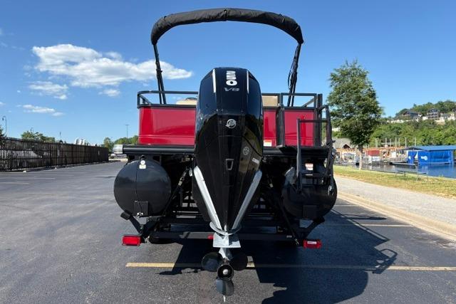 2025 Regency 250 DL3 pontoon boat with powerful outboard motor, parked on sunny day.