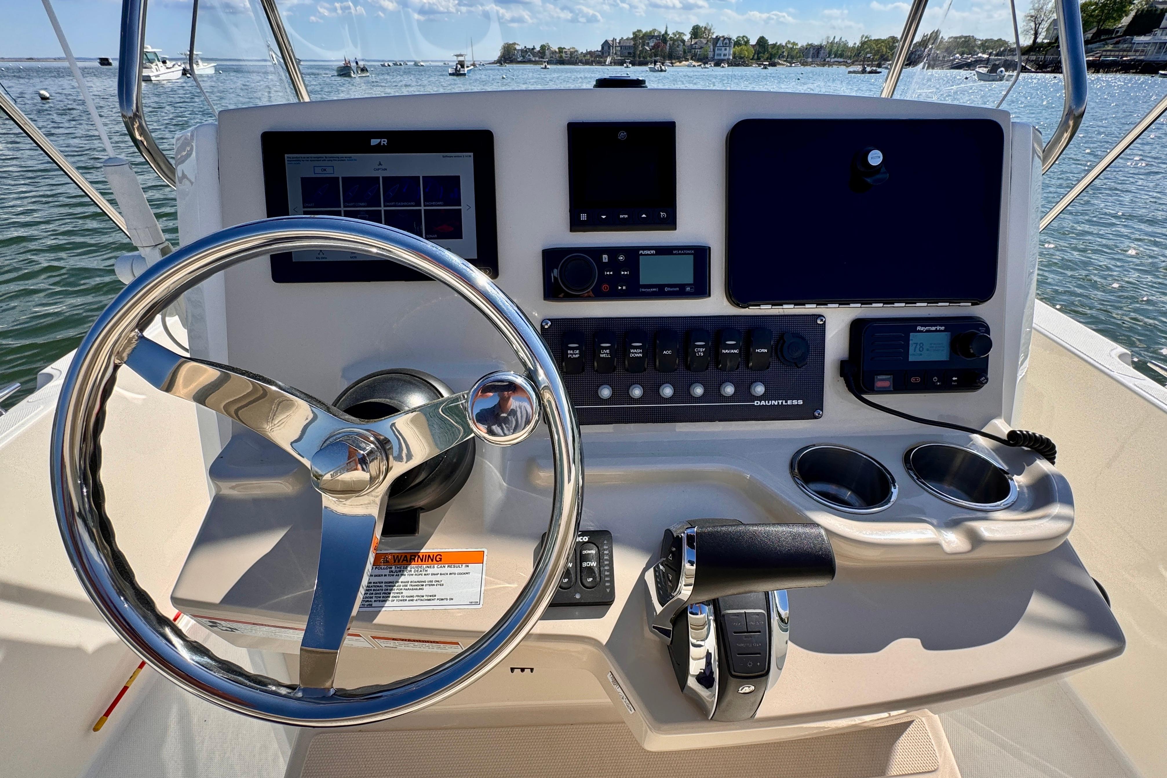 2022 Boston Whaler 220 Dauntless helm with steering wheel and control panel.