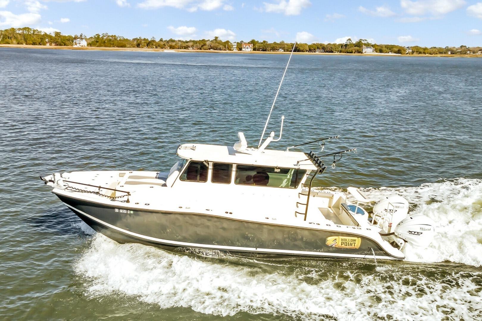 2024 Custom Nerowalker 35 boat cruising on a sunny day, featuring dual outboard engines.