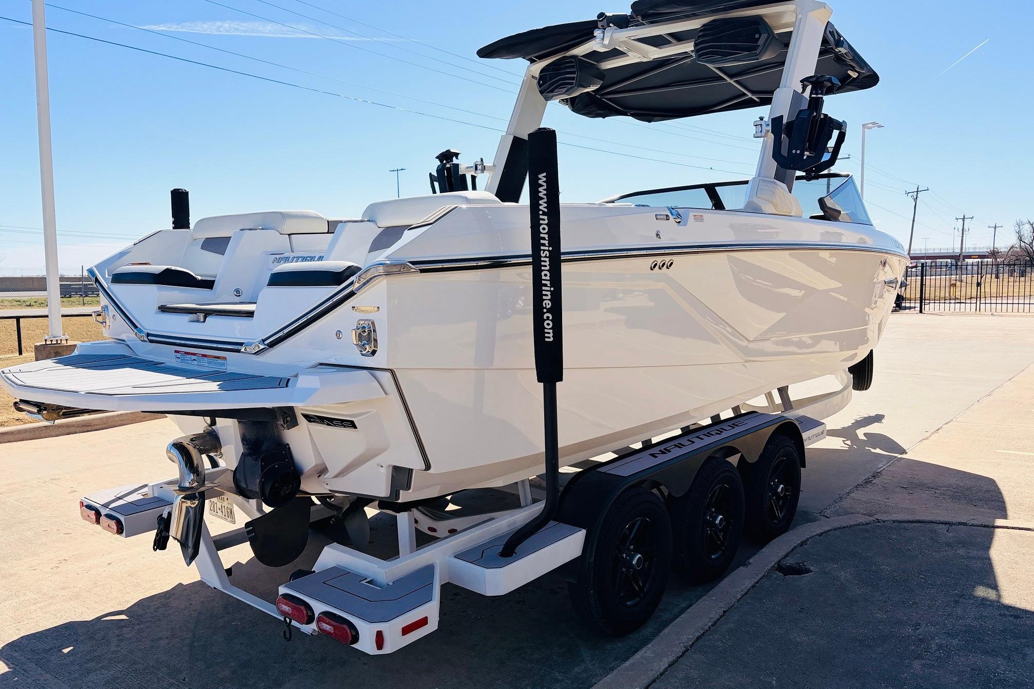 2023 Nautique Super Air Nautique G25 boat on trailer, rear view in sunlight.