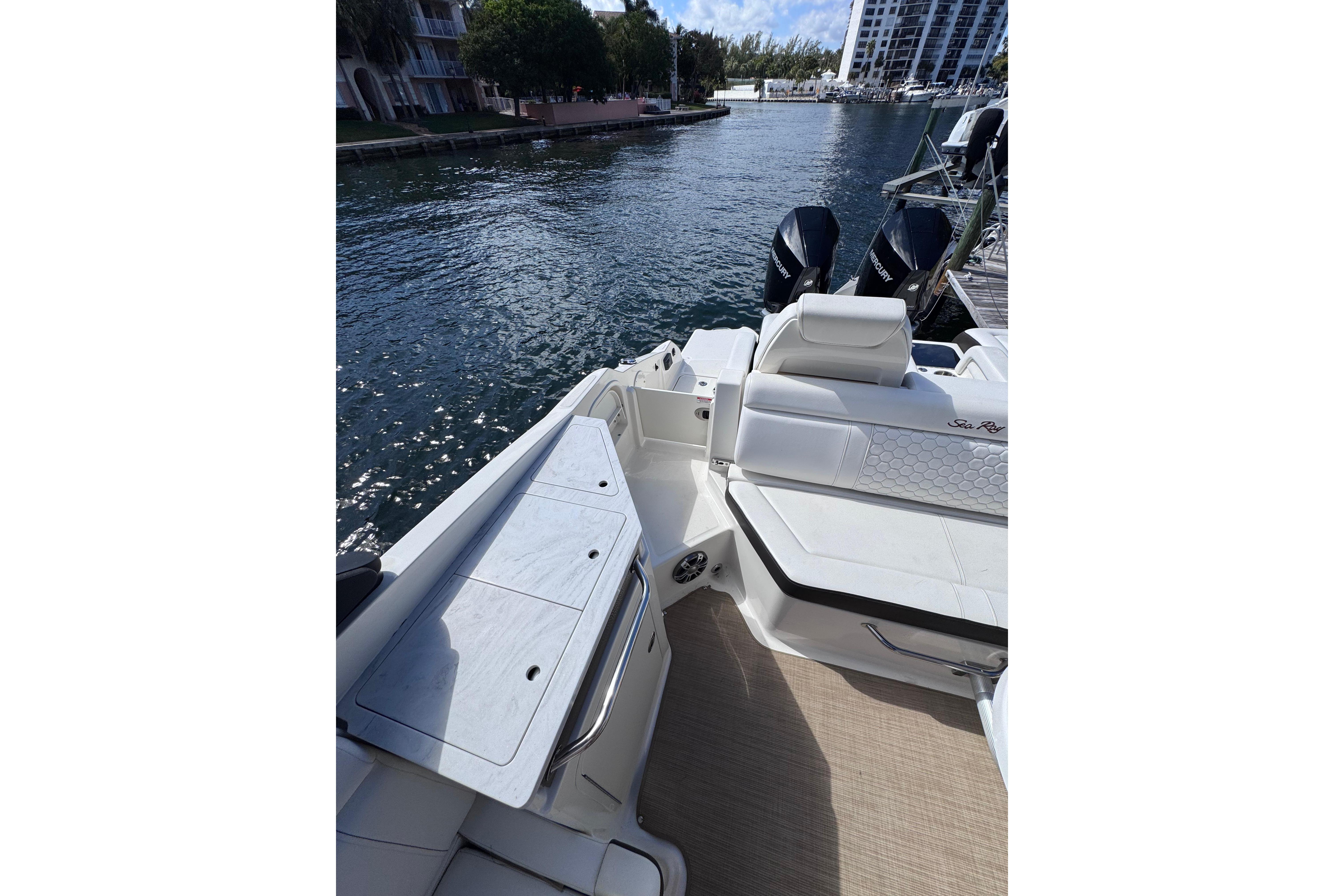 2024 Sea Ray SDX 290 Outboard boat interior with waterfront view.