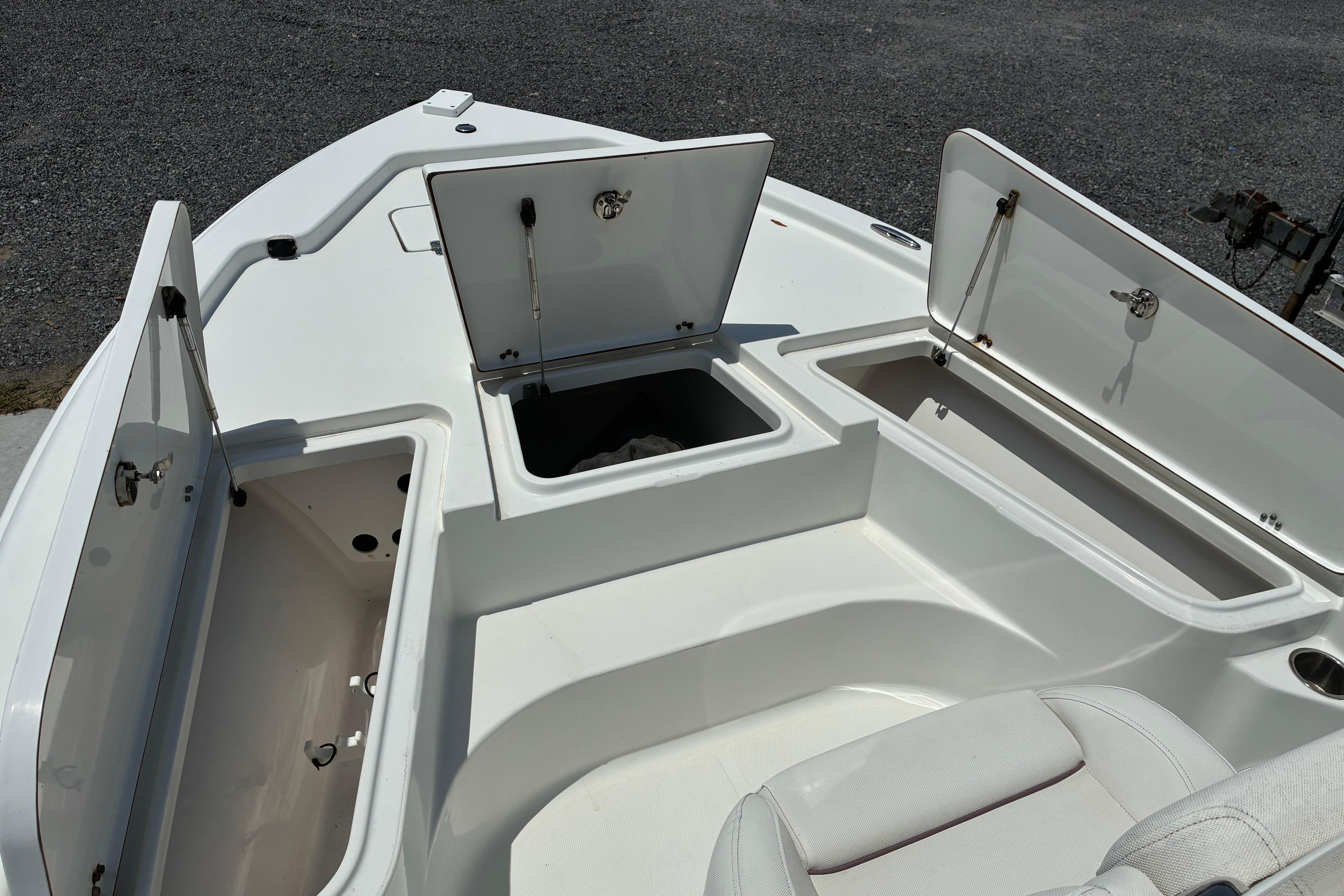 2014 Sea Hunt BX 20 BR boat with open storage compartments on deck.