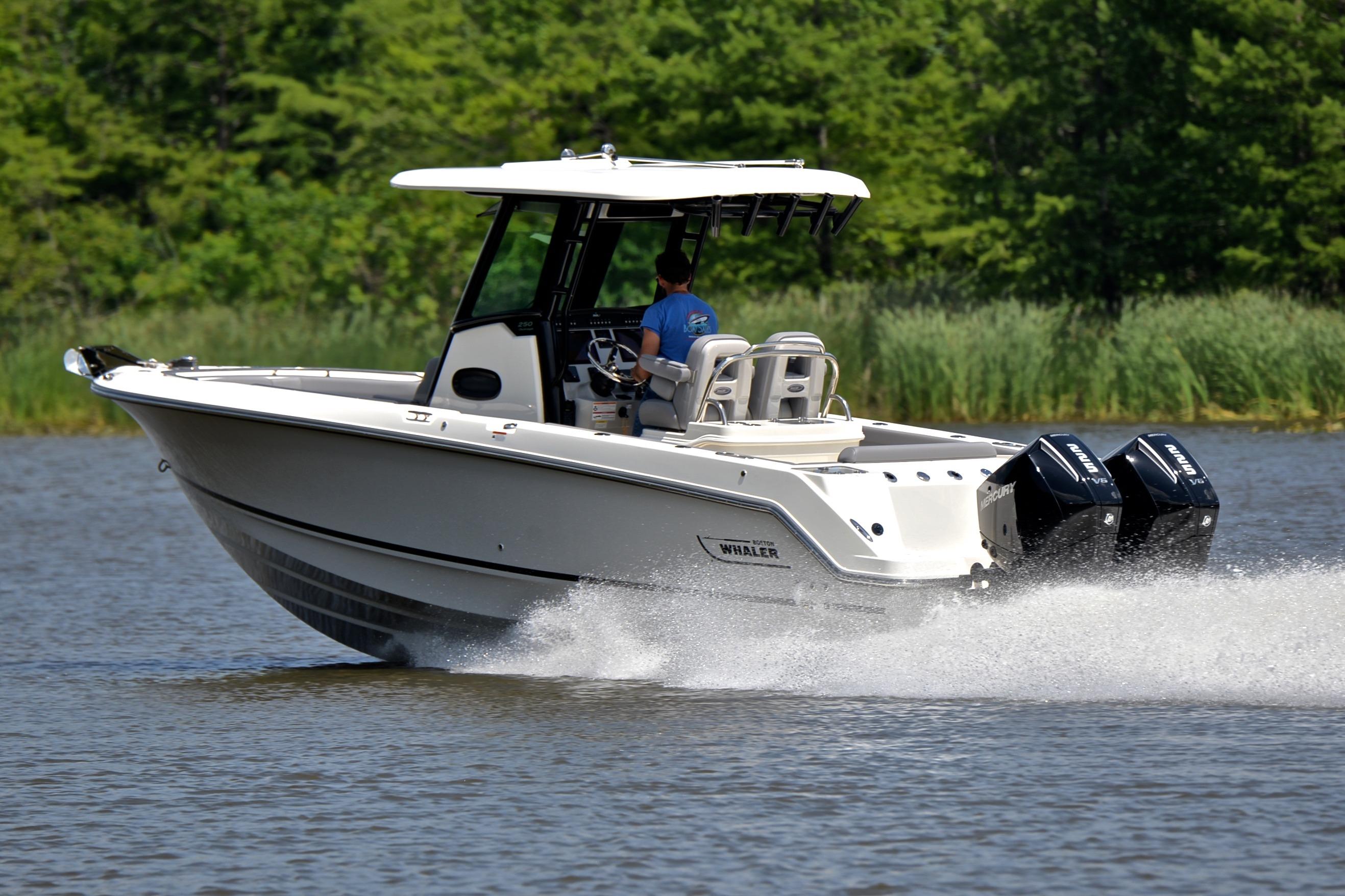2024 Boston Whaler 250 Outrage cruising on a lake with dual engines.