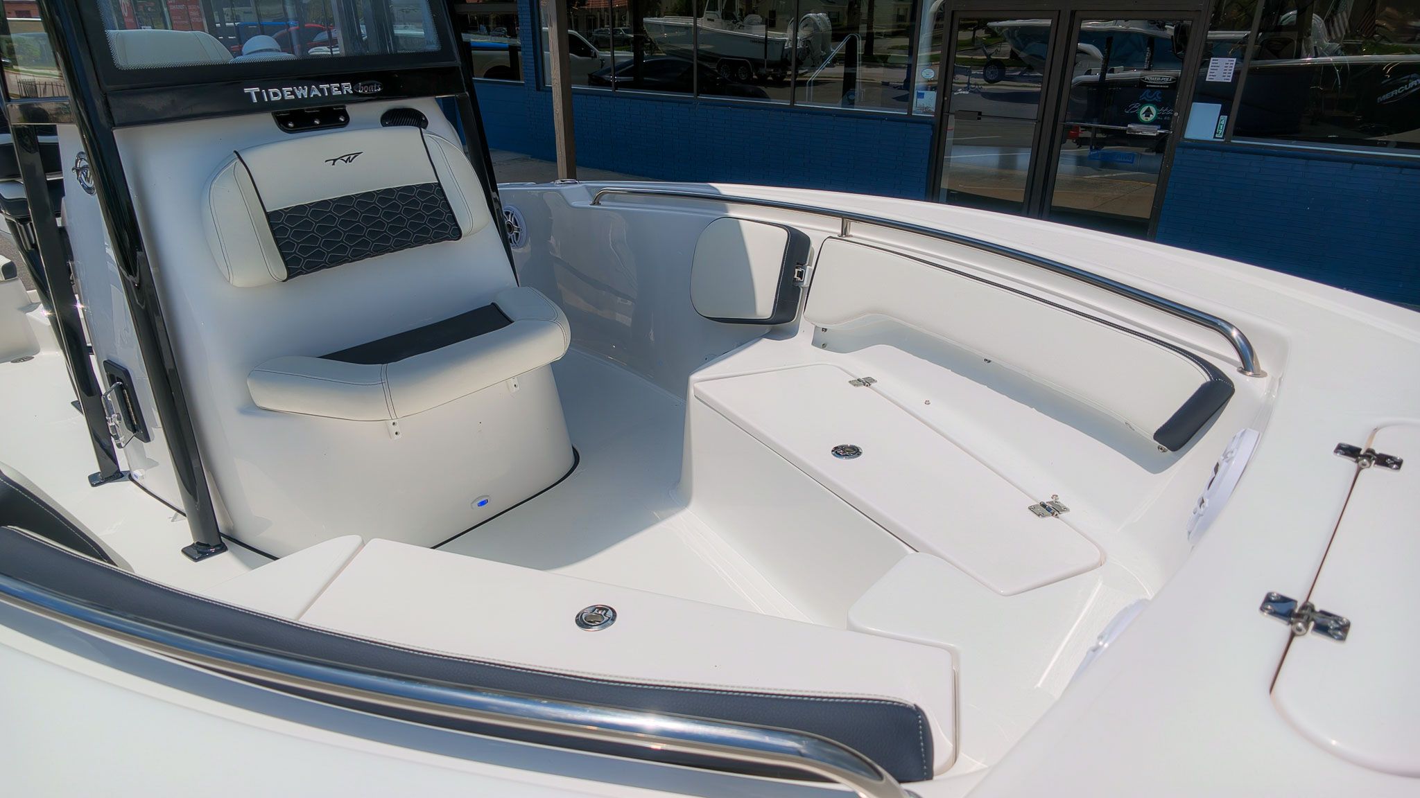 The image shows the cockpit of a Tidewater 198 CC Adventure boat with seating and storage.