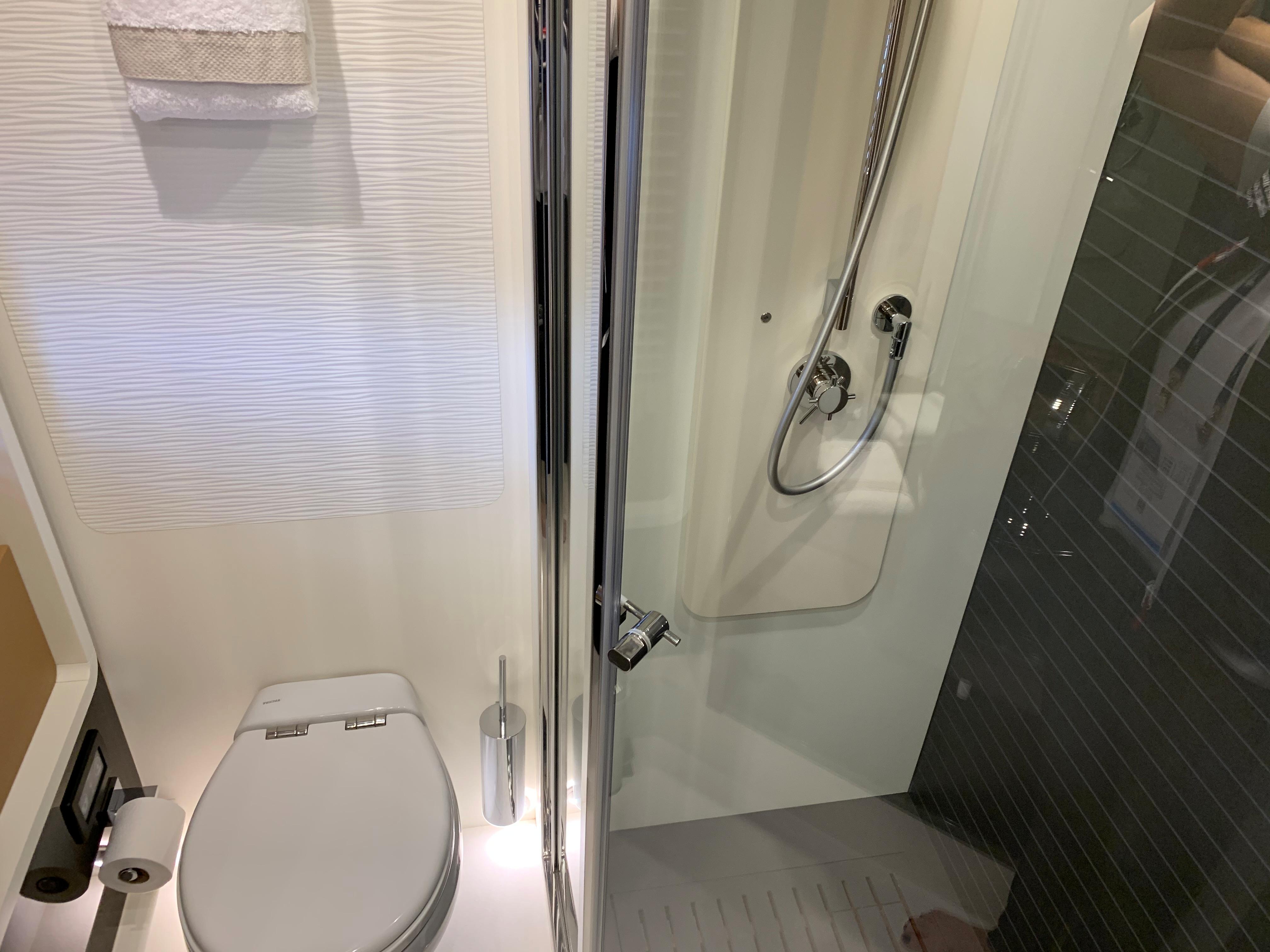 Modern bathroom on a 2019 Azimut 77S yacht with shower and toilet.